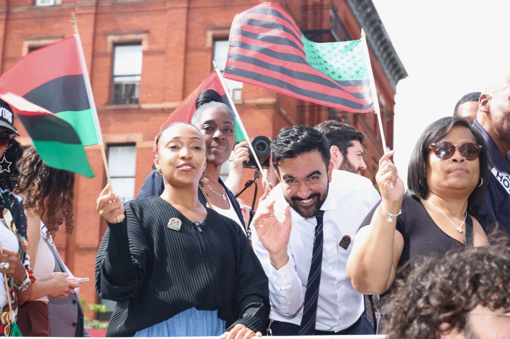 Zohran Mamdani waves to the crowd at the 56th Annual African American Day Parade.