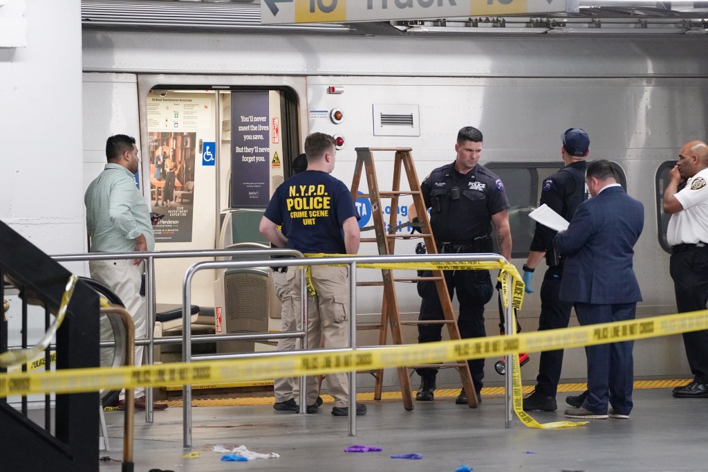 Police and crime scene tape at the Long Island Railroad area of Penn Station after a shooting.
