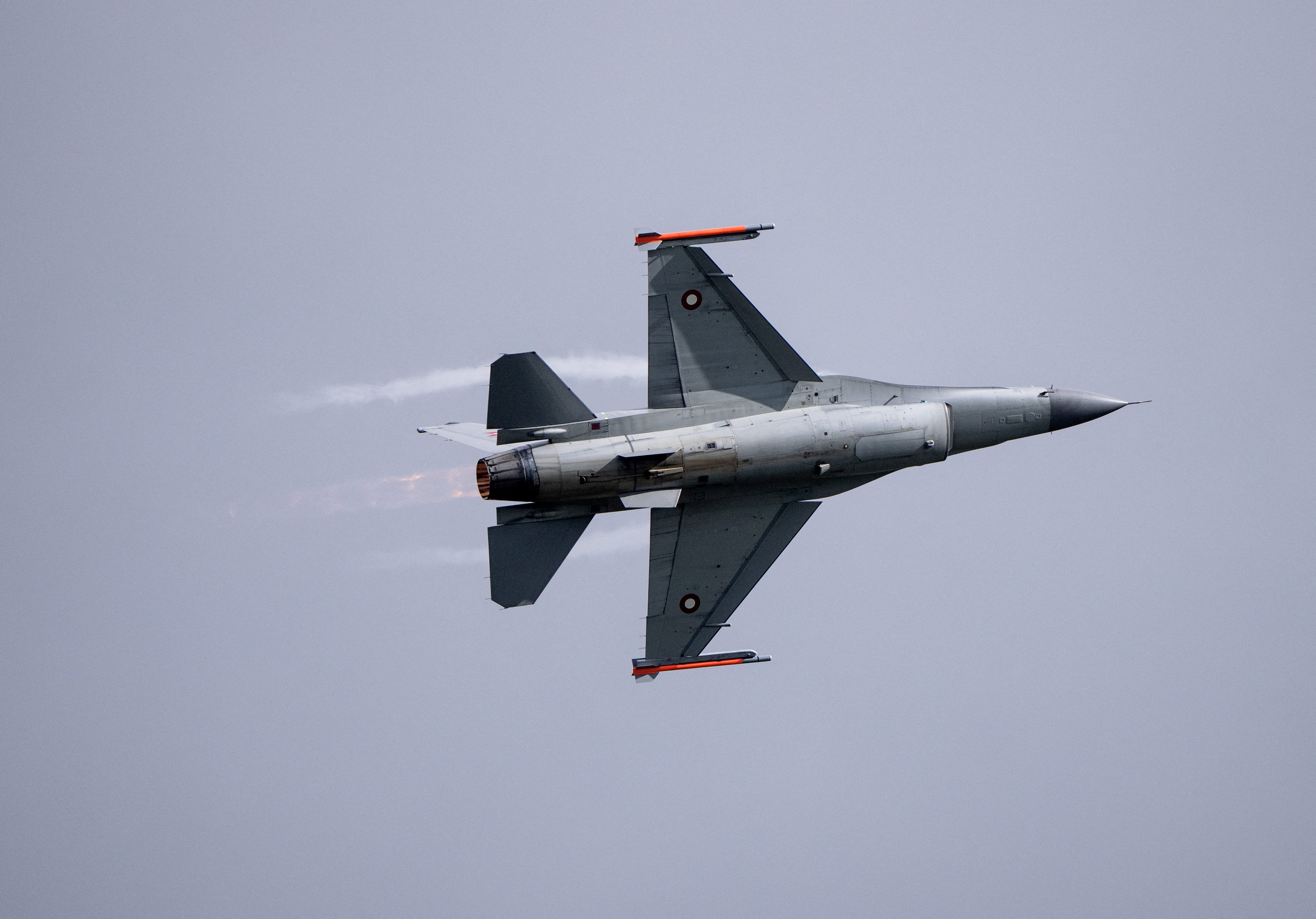 A grey fighter jet in the sky