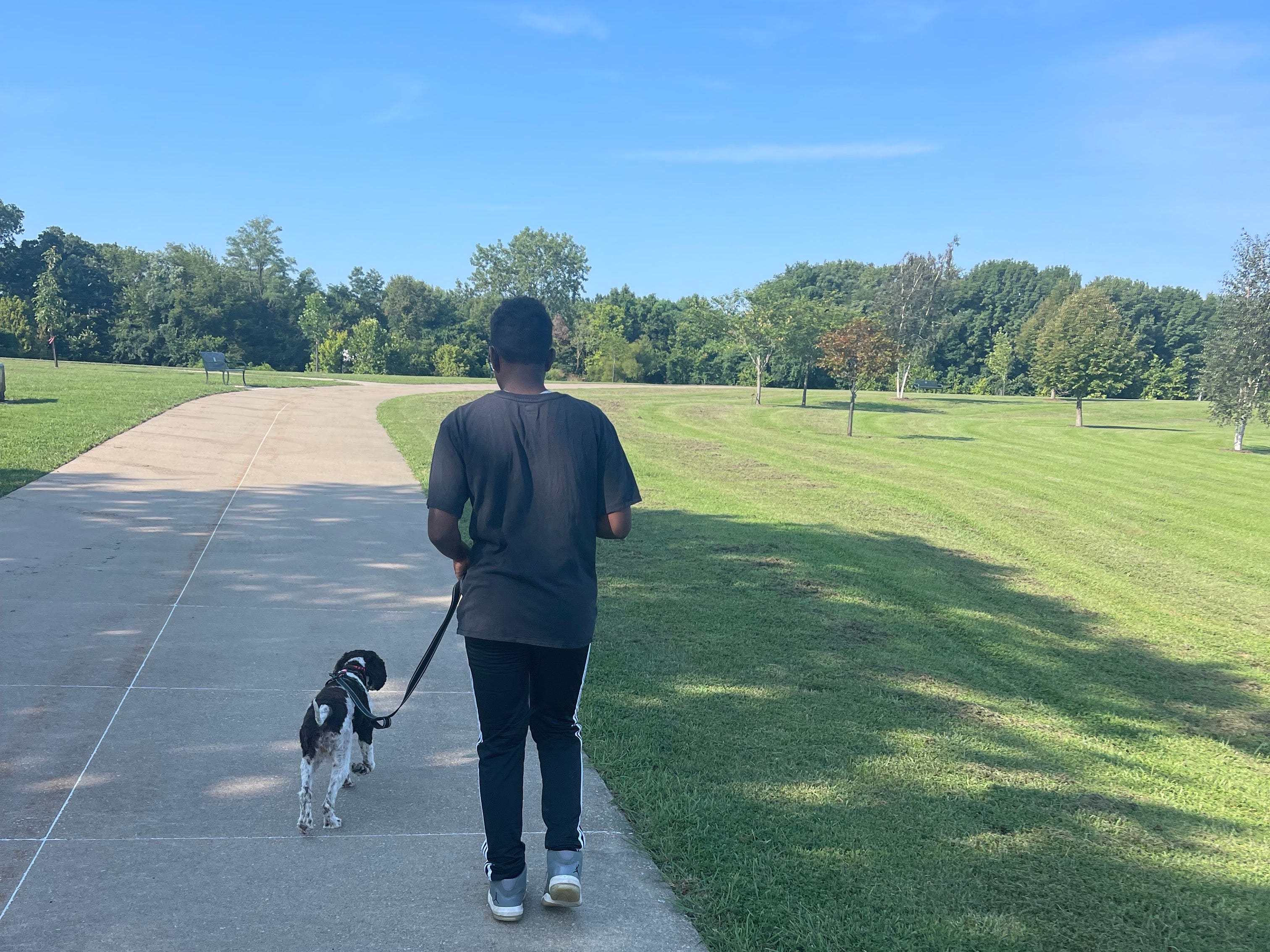 Kid walking dog
