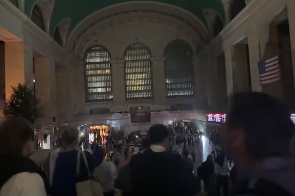 Grand Central Terminal during a power outage, with many people and dimmed lighting.