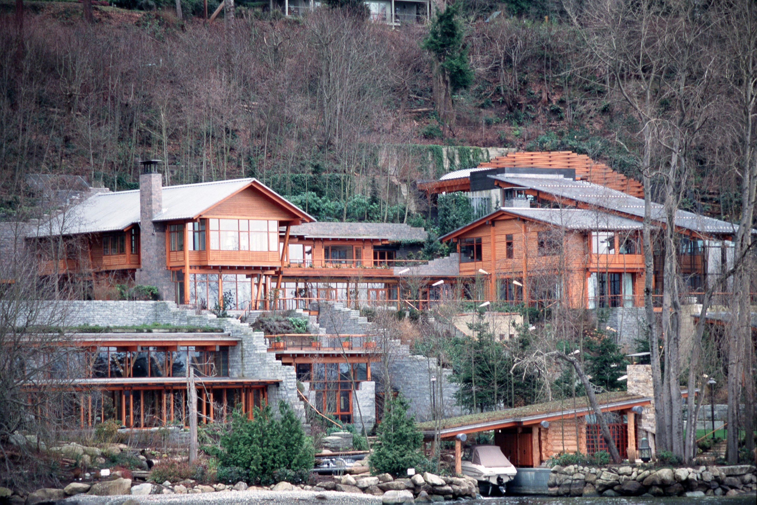 Bill Gates' multistory lakefront mansion in Medina, Washington, is surrounded by trees.
