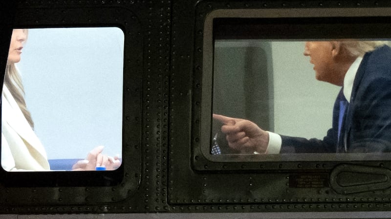 US President Donald Trump speaks with First Lady Melania Trump onboard Marine One