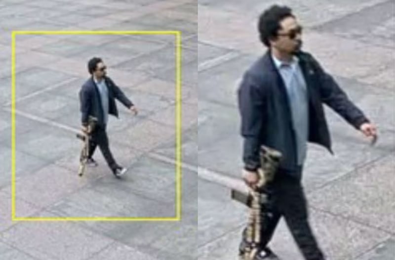 Security footage shows that Shane Tamura walked into a Midtown Manhattan office building while openly carrying a rifle.