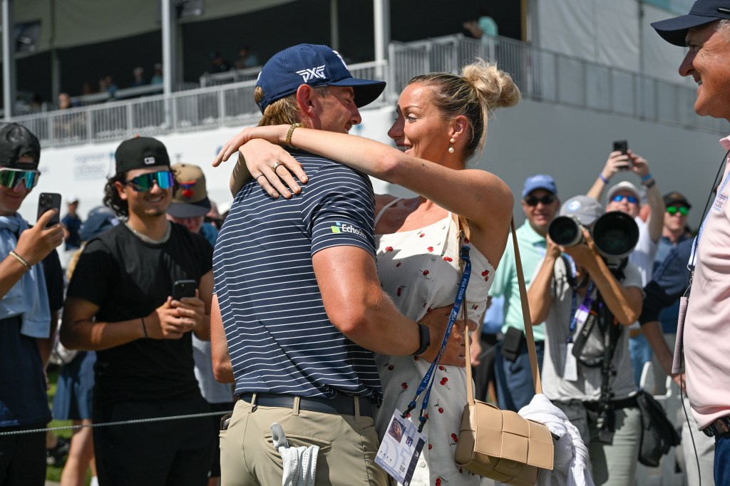 PALM BEACH GARDENS, FLORIDA - FEBRUARY 27: Jake Knapp hugs his girlfriend, Makena White, while walking off the 18th green during the first round of the Cognizant Classic in The Palm Beaches at PGA National Resort the Champion Course on February 27, 2025 in Palm Beach Gardens, Florida. (Photo by Ben Jared/PGA TOUR via Getty Images)
