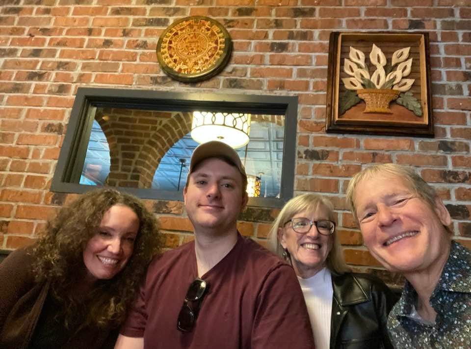 People posing for a photo at bar
