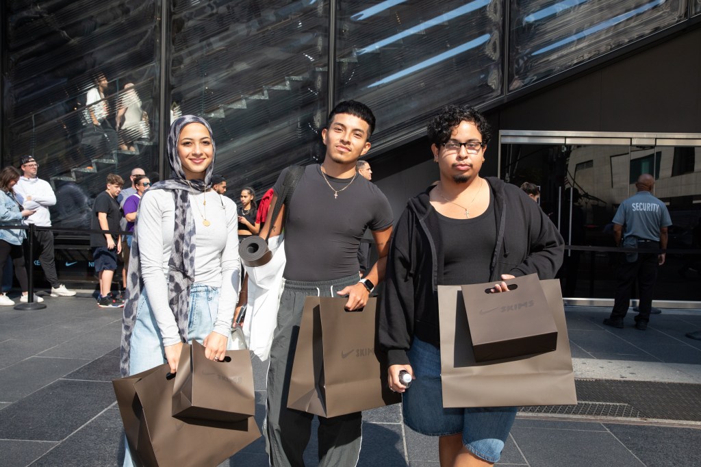 Engy Noeman, David Paguay, and Michael Pina with their purchases in front of the 5th Avenue Nike store after the launch of the Skims/Nike Kim Kardashian collection.