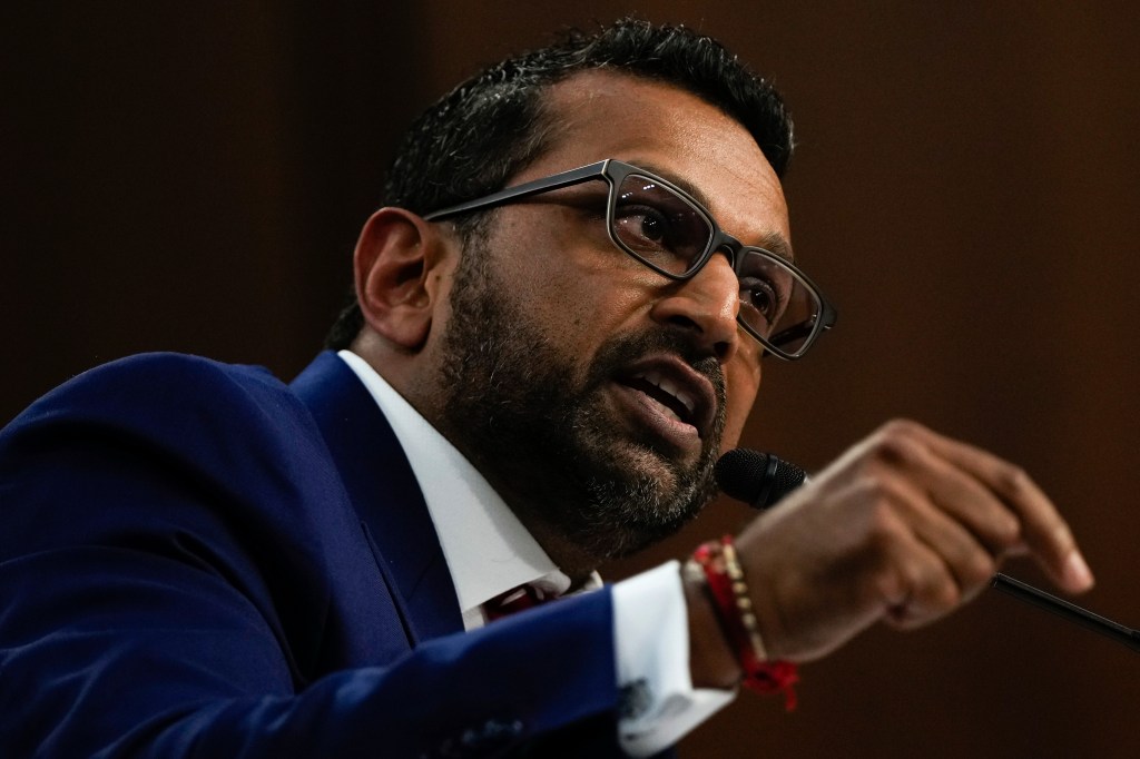 Kash Patel speaking at a microphone.