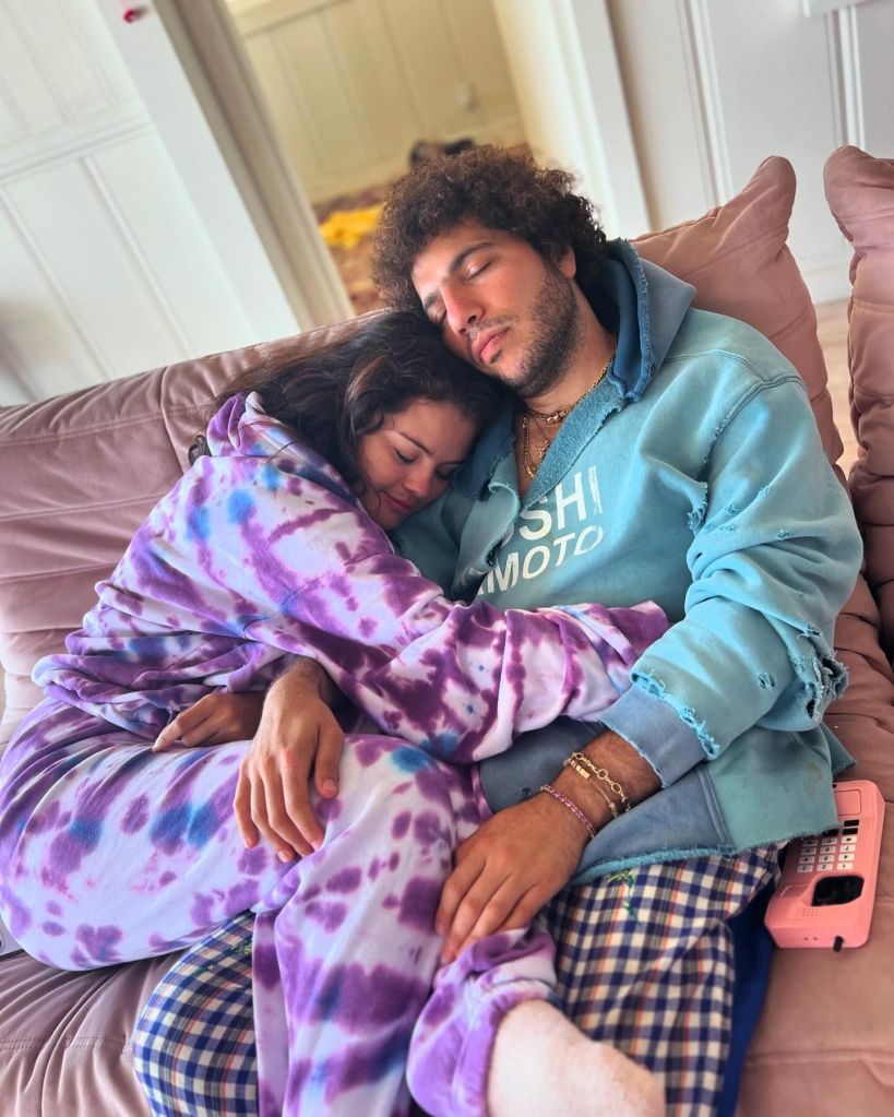 Selena Gomez in a purple tie-die onesie, Benny Blanco in a green jacket  and pajama bottoms.