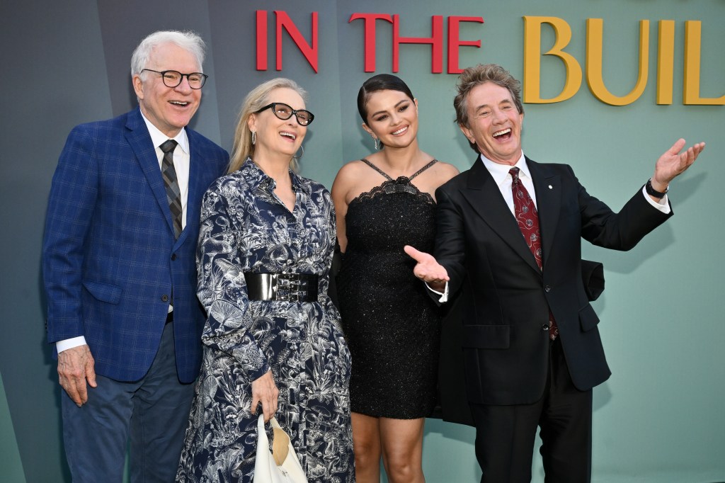 From left: Steve Martin in a blue blazer and grey pants, Meryl Streep in a grey pattered dress and black belt, Selena Gomez in a black dress, Martin Short in a black suit and red tie.