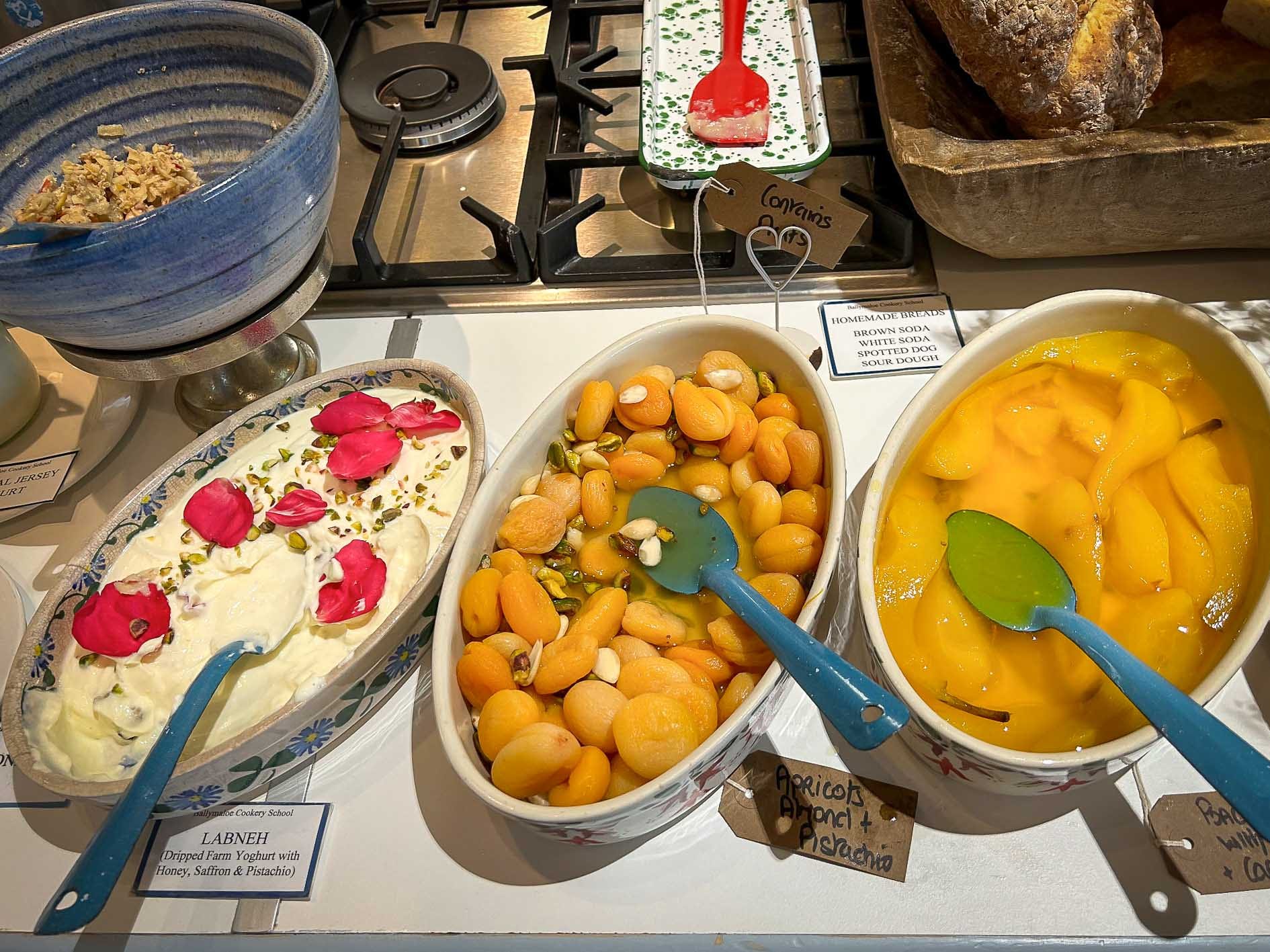 Labneh yogurt and poached fruit at a breakfast buffet.