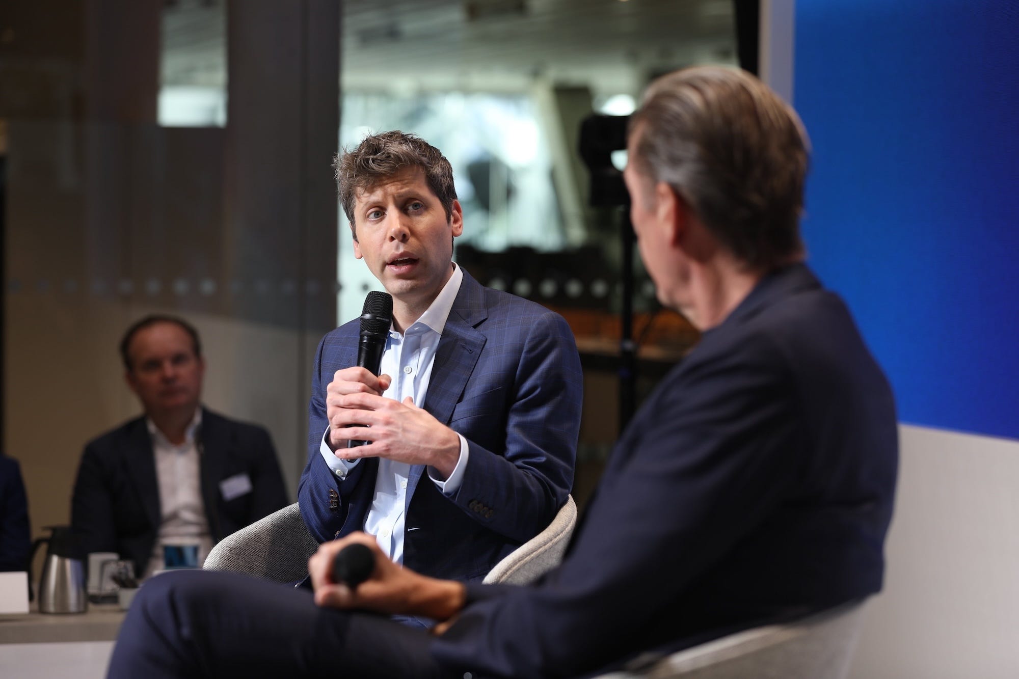 Sam Altman talks into a microphone.