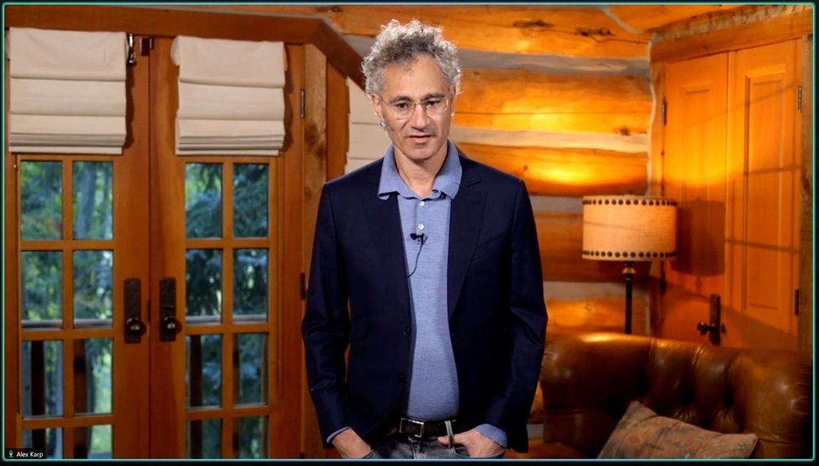 Alex Karp joins a video call from a contemporary wood cabin.