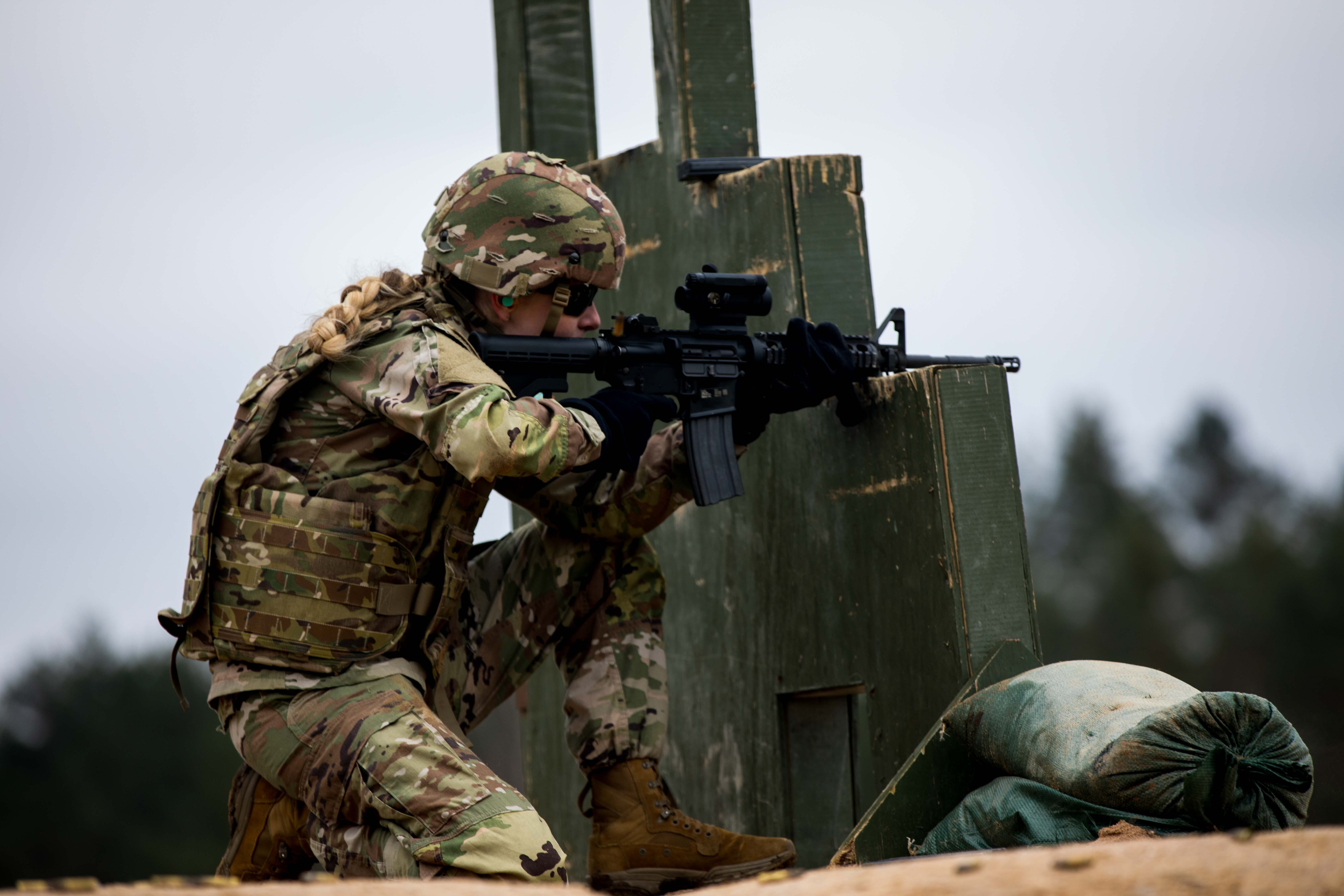A US Army Reserve drill sergeant fires an M4 rifle at a training range in Germany in February 2024.