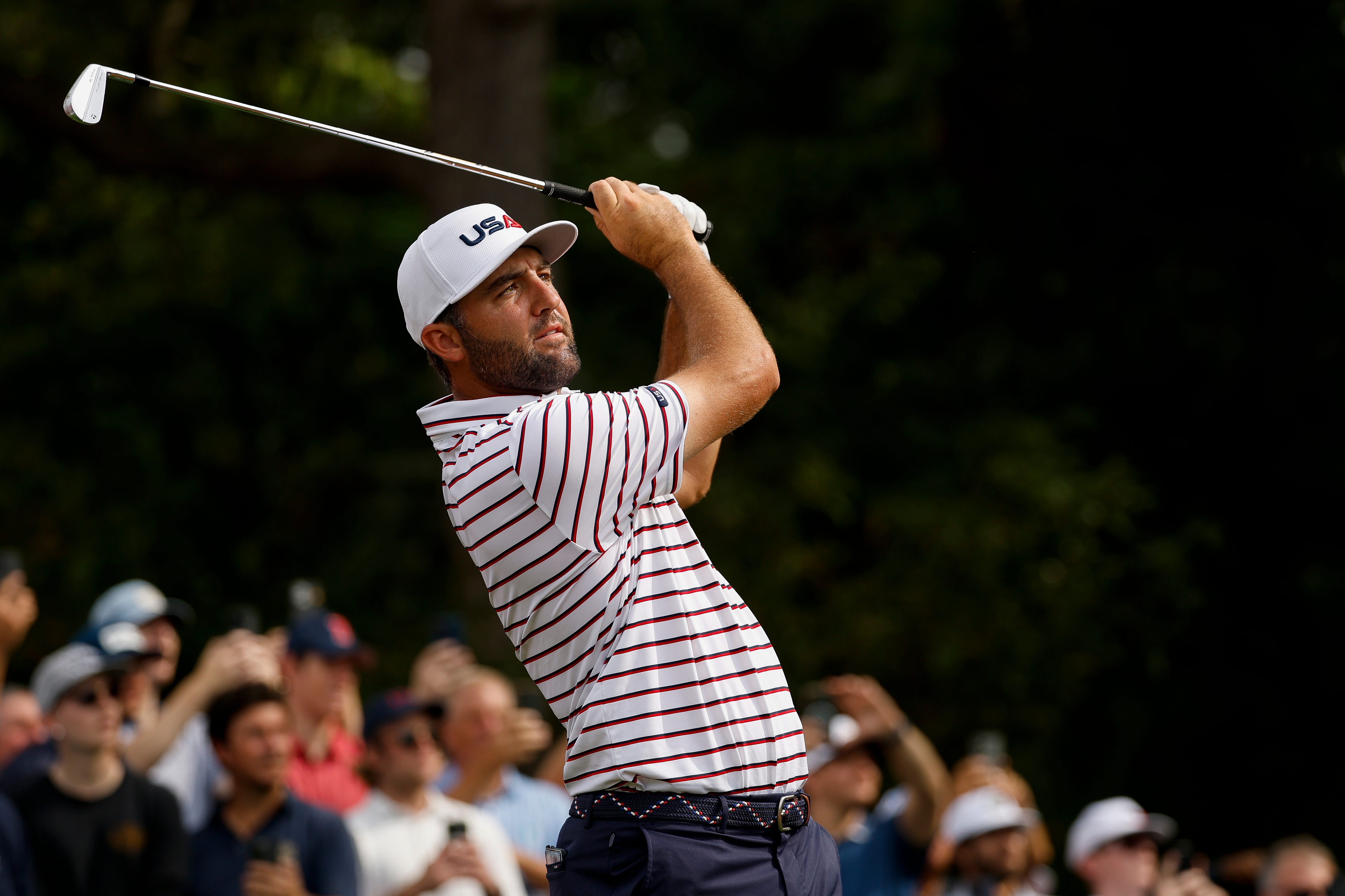 Scottie Scheffler of Team United States, wearing a USA baseball cap, swings his golf club prior to the Ryder Cup 2025.