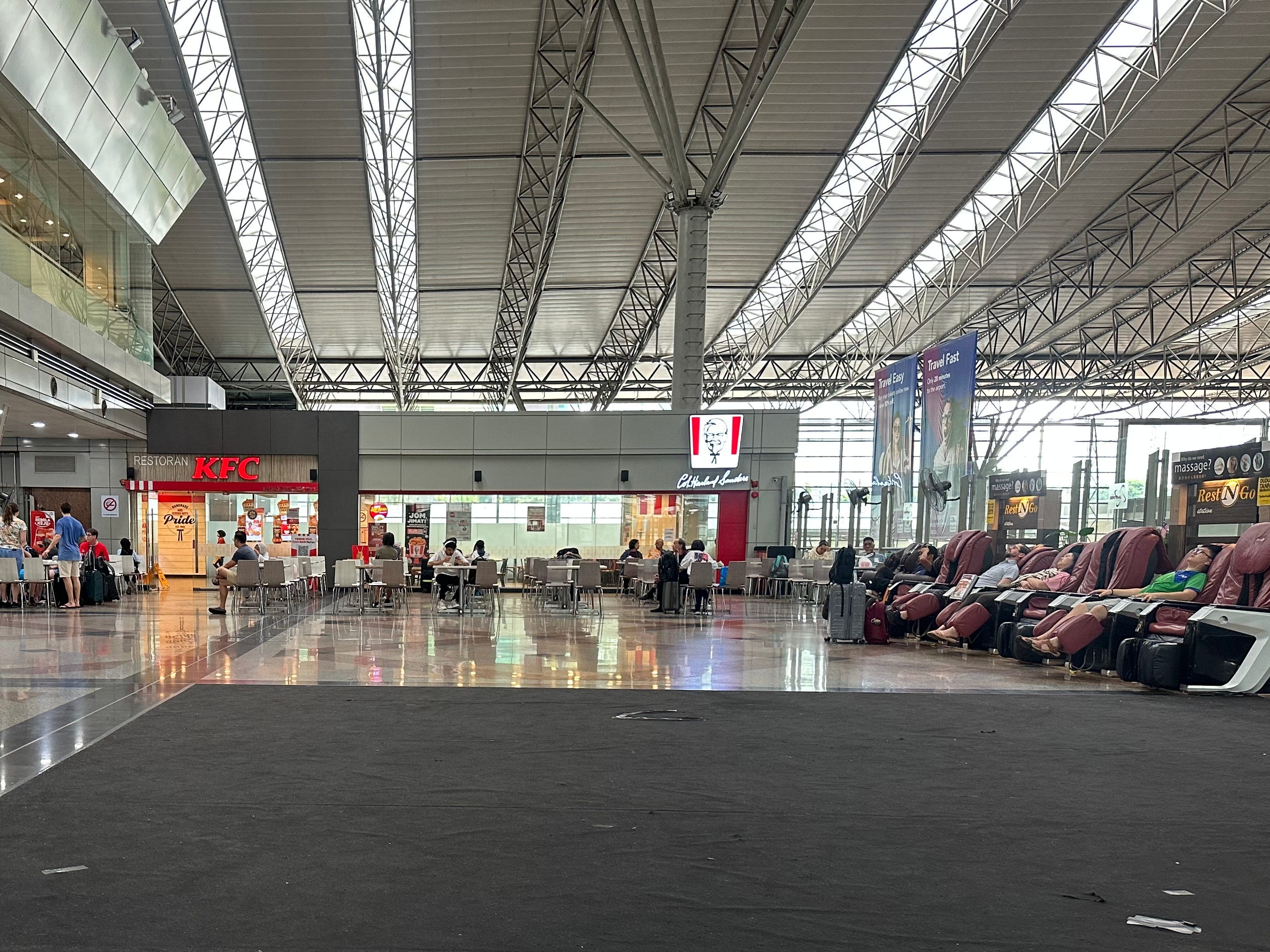 View of KFC window, seating, and massage chairs in lounge
