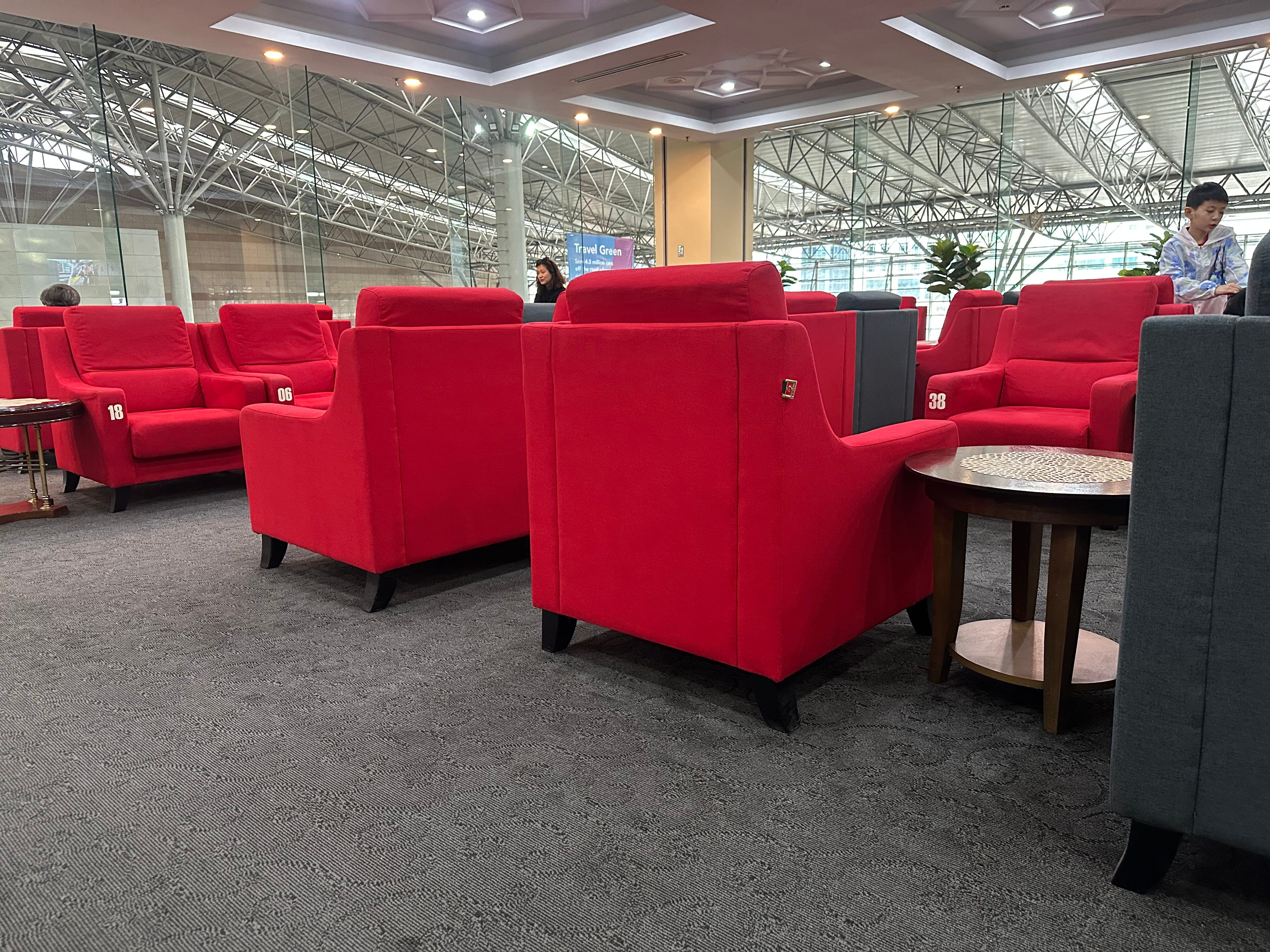 Ruby red cushioned chairs on gray carpet