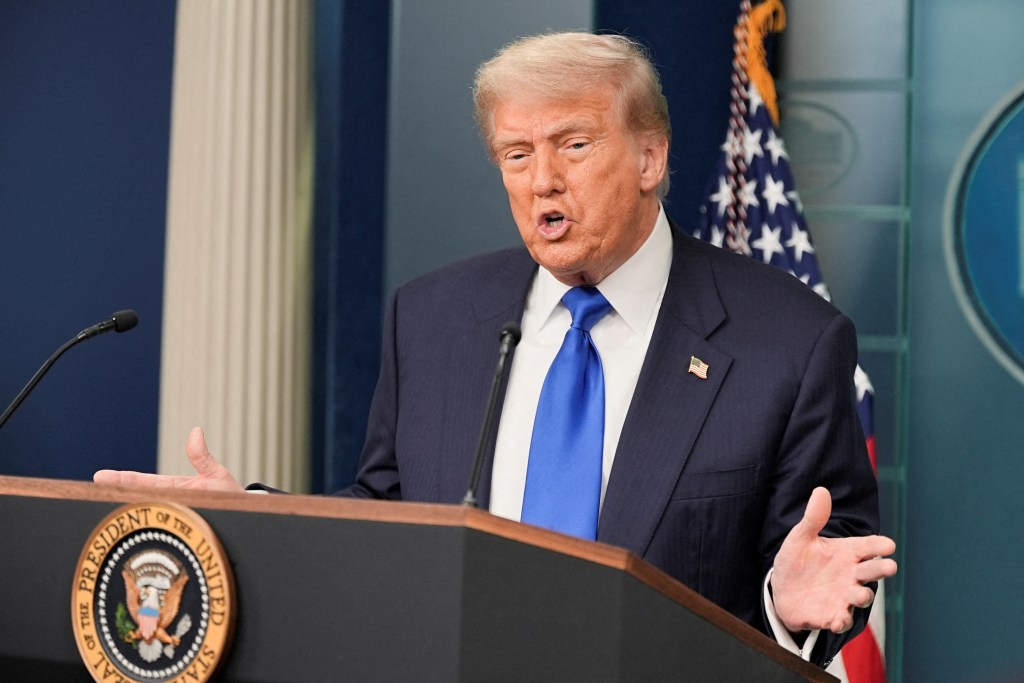 U.S. President Donald Trump speaks to the media at a podium in the White House.