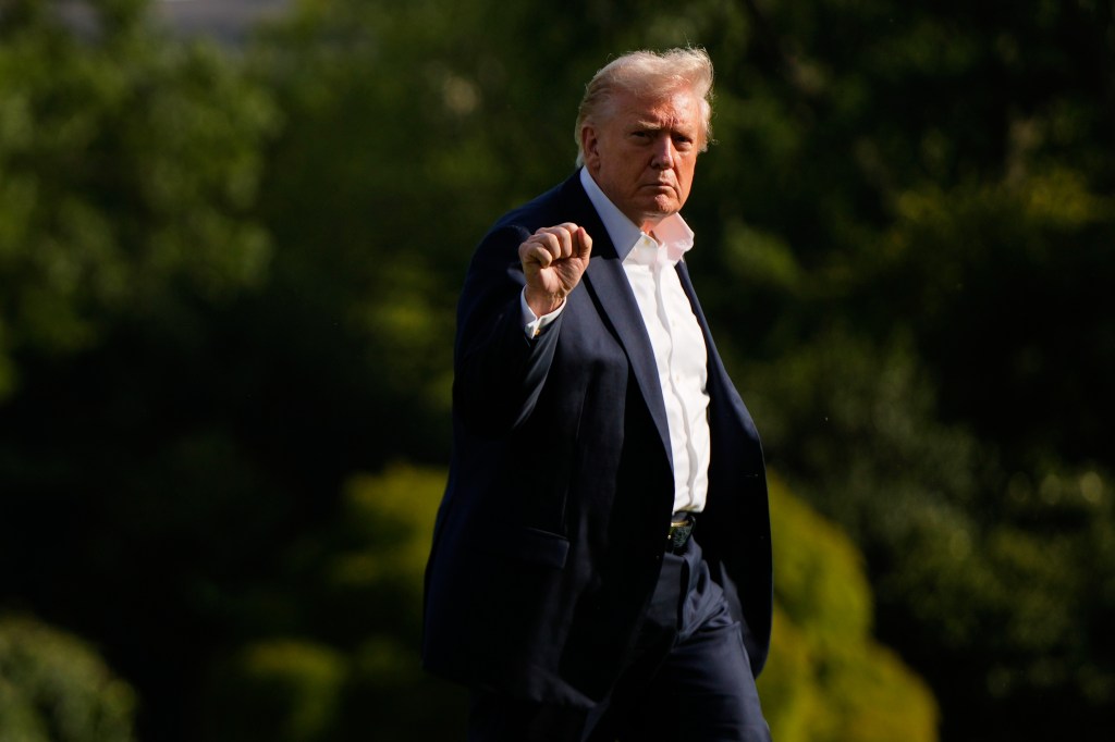 President Donald Trump gestures as he arrives at the White House.