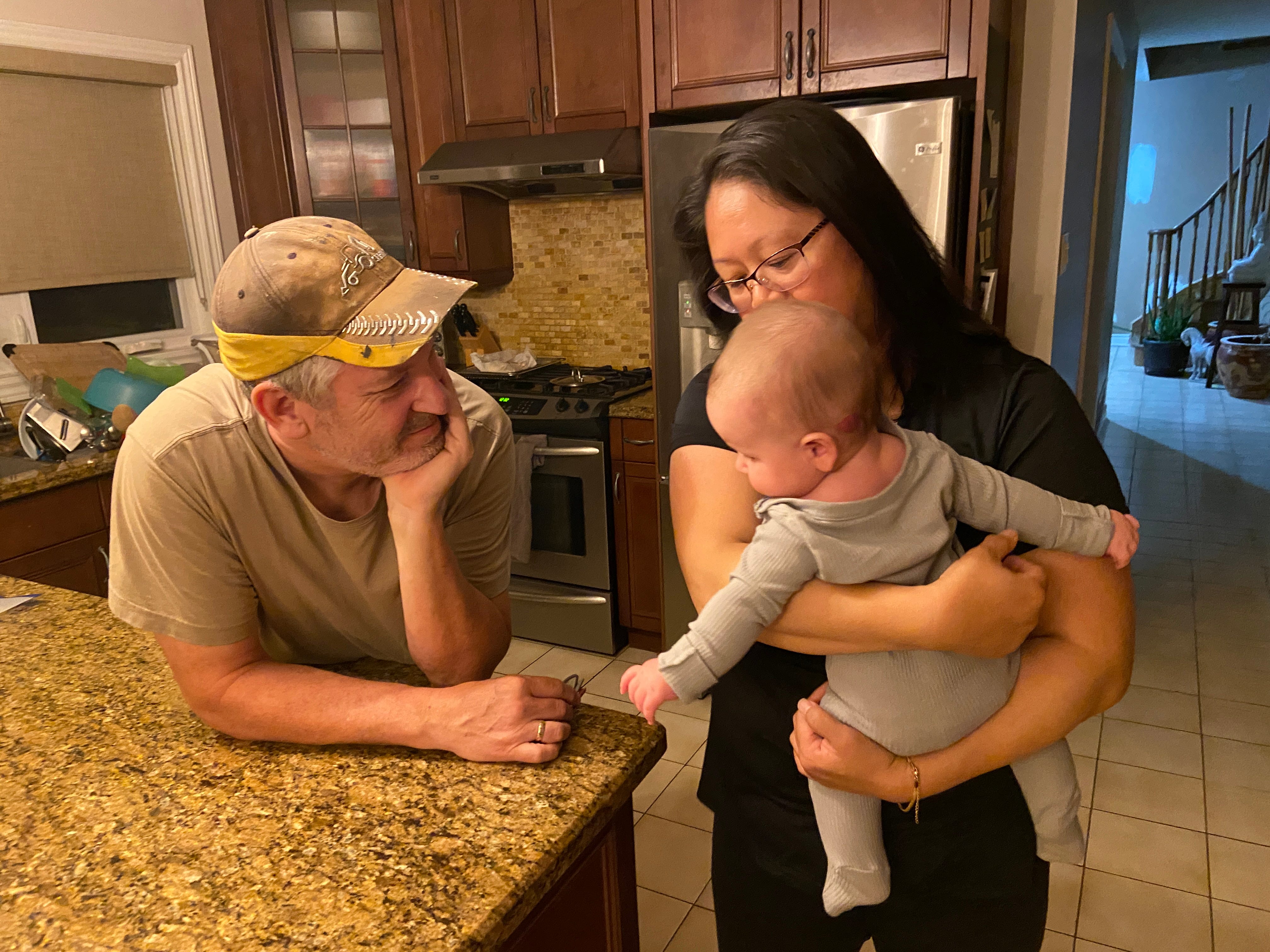 The author's parents with their granddaughter in the kitchen of their home.