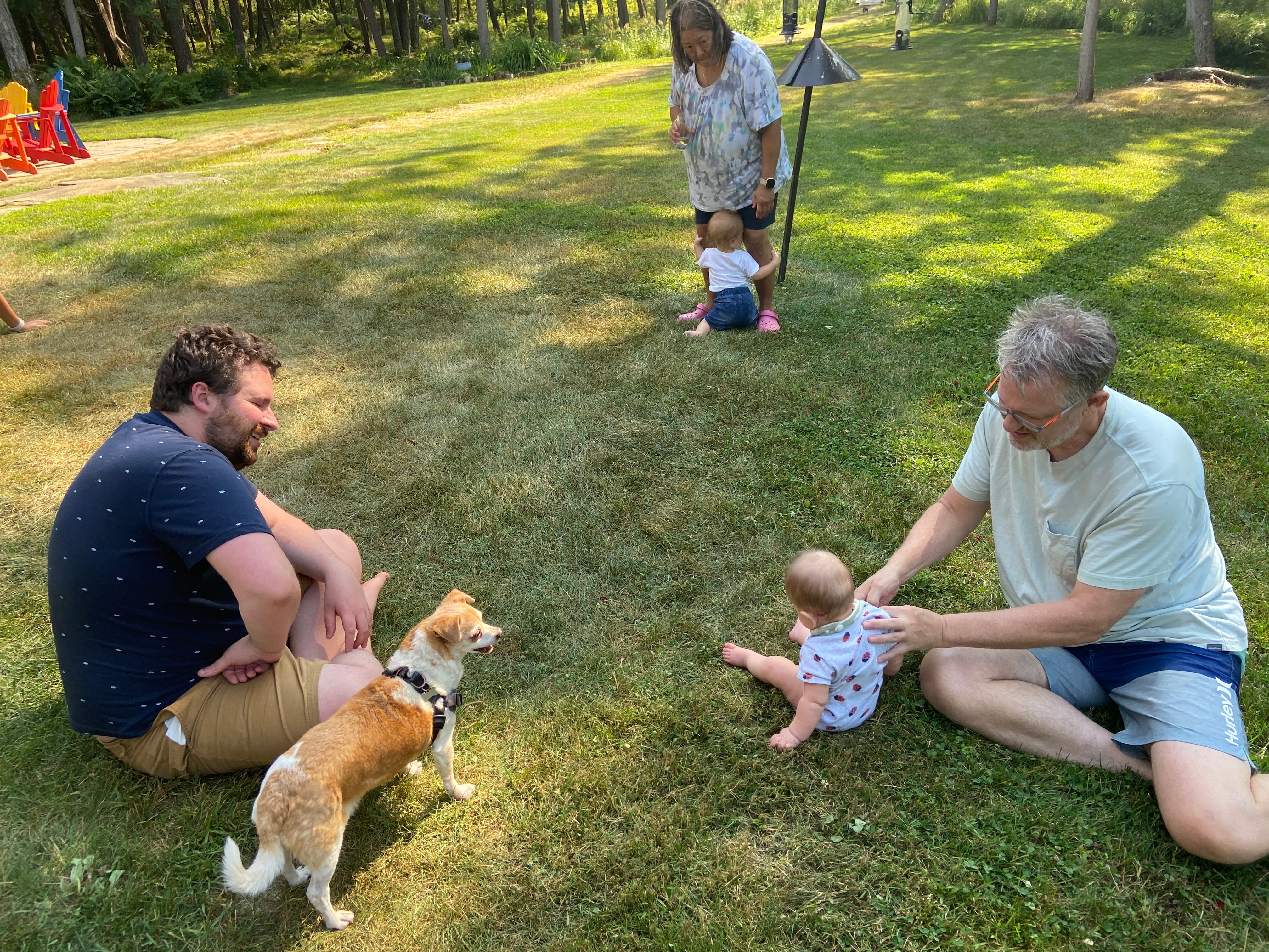 The author's dad, husband, dog, daughter and other family members enjoying time in the backyard.