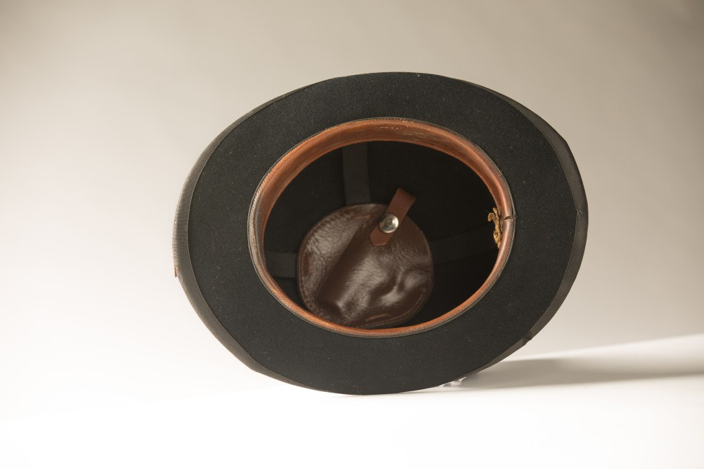 Bowler hat with concealed pistol holder.