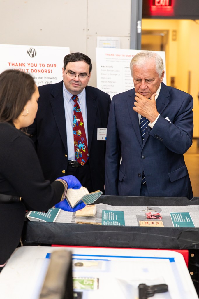 Reade Williams examining artifacts in the International Spy Museum's SPY Vault.