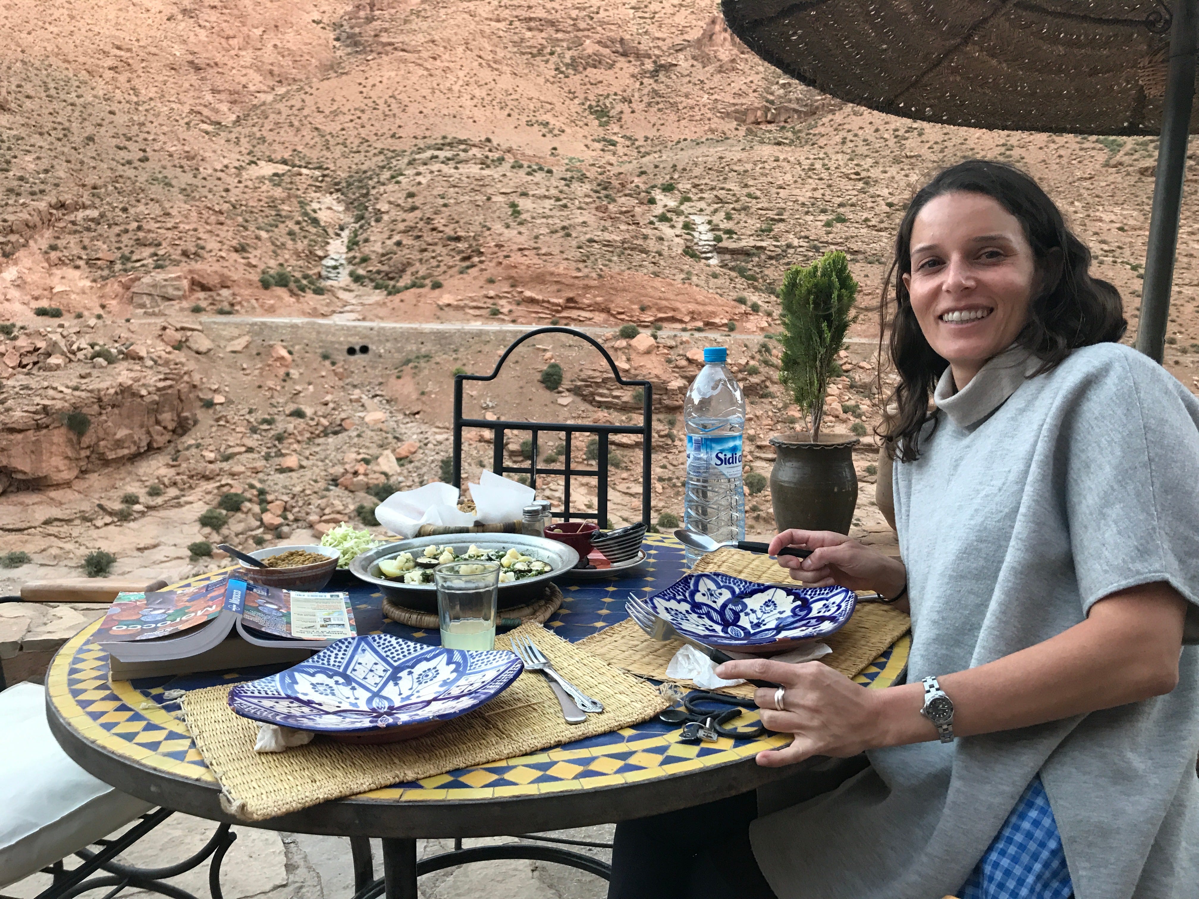 A woman sitting at a table in Morocco