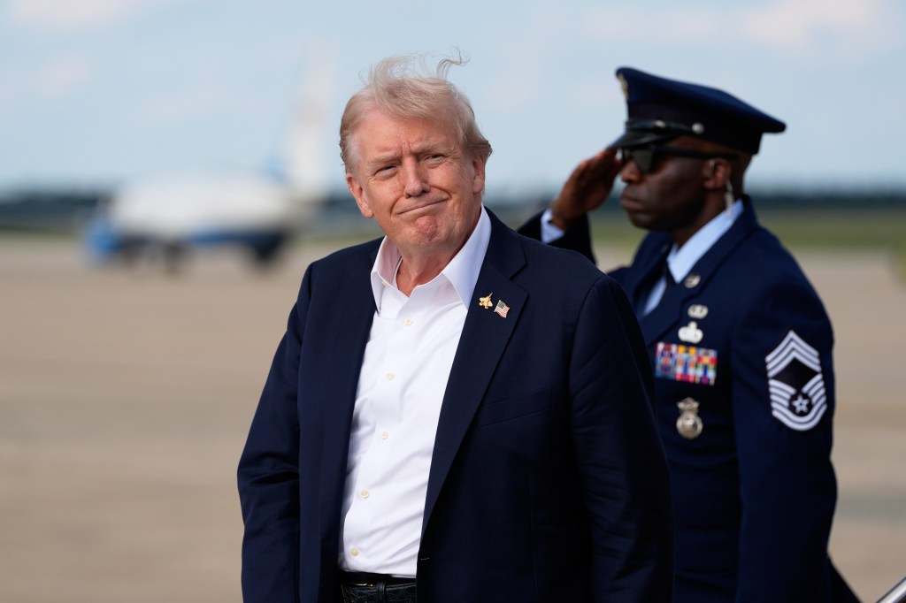 Donald Trump exiting Air Force One with an Air Force officer saluting in the background.