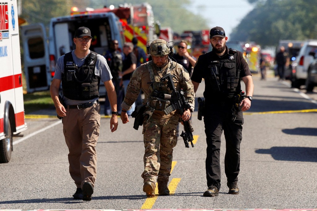 Police and emergency personnel work at the scene of a shooting in Grand Blanc, Michigan.