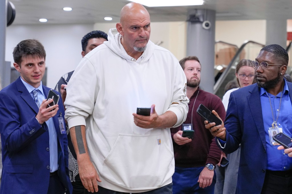 Sen. John Fetterman speaks with reporters in the Capitol subway.