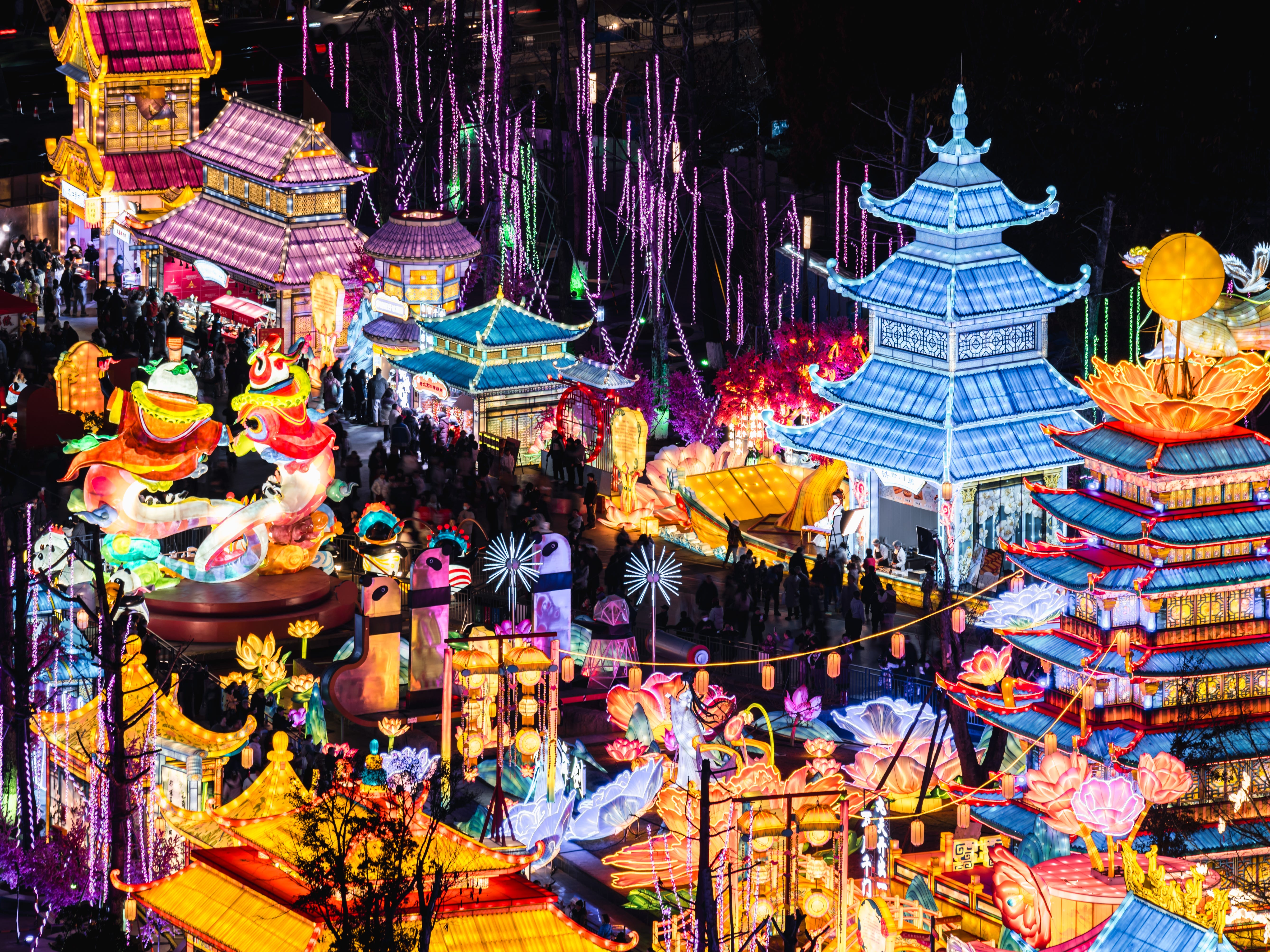 People stroll through colorful lantern installations at the 54th Chengdu International Panda Lantern Festival in Chengdu, Sichuan Province of China.