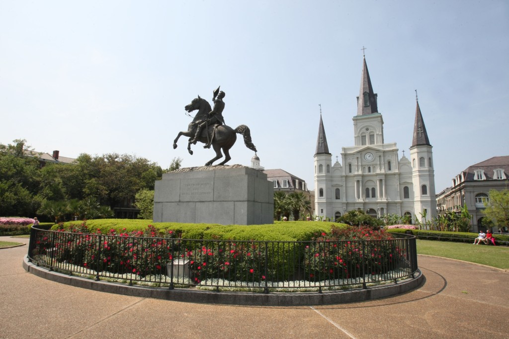 Jackson Square in New Orleans with an equestrian statue and St. Louis Cathedral.