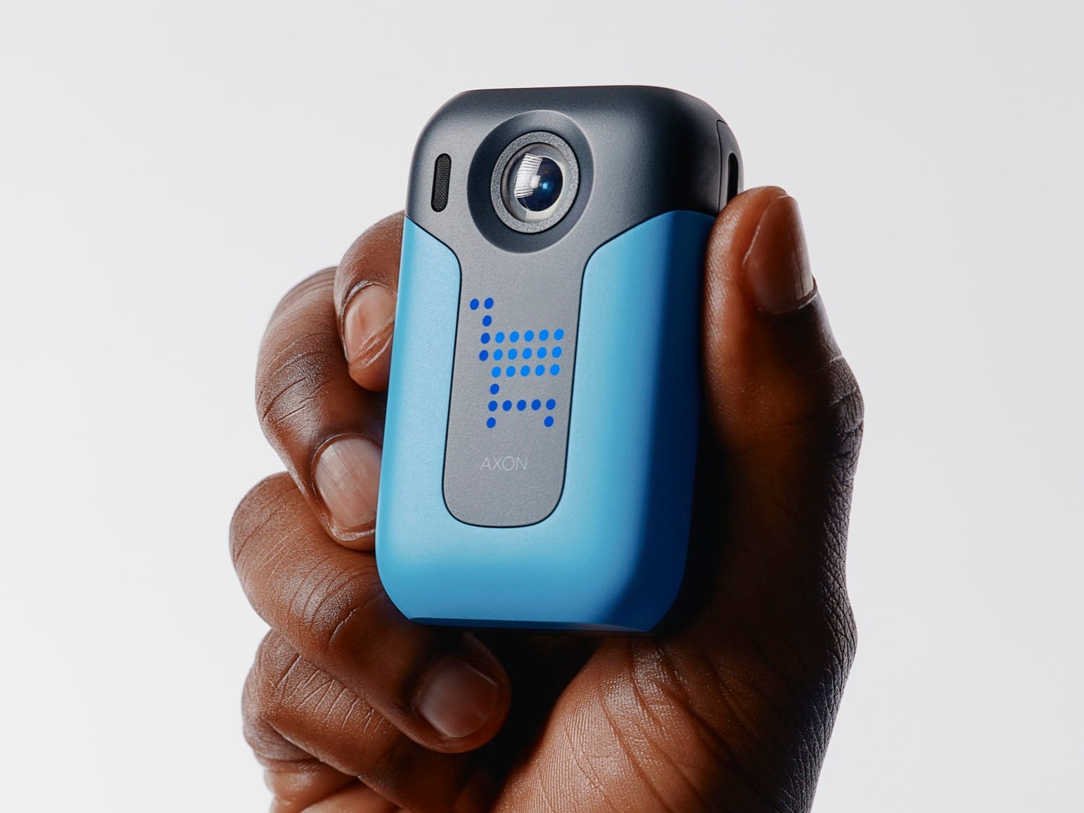 A model holds the Axon Body Workforce Mini body camera.