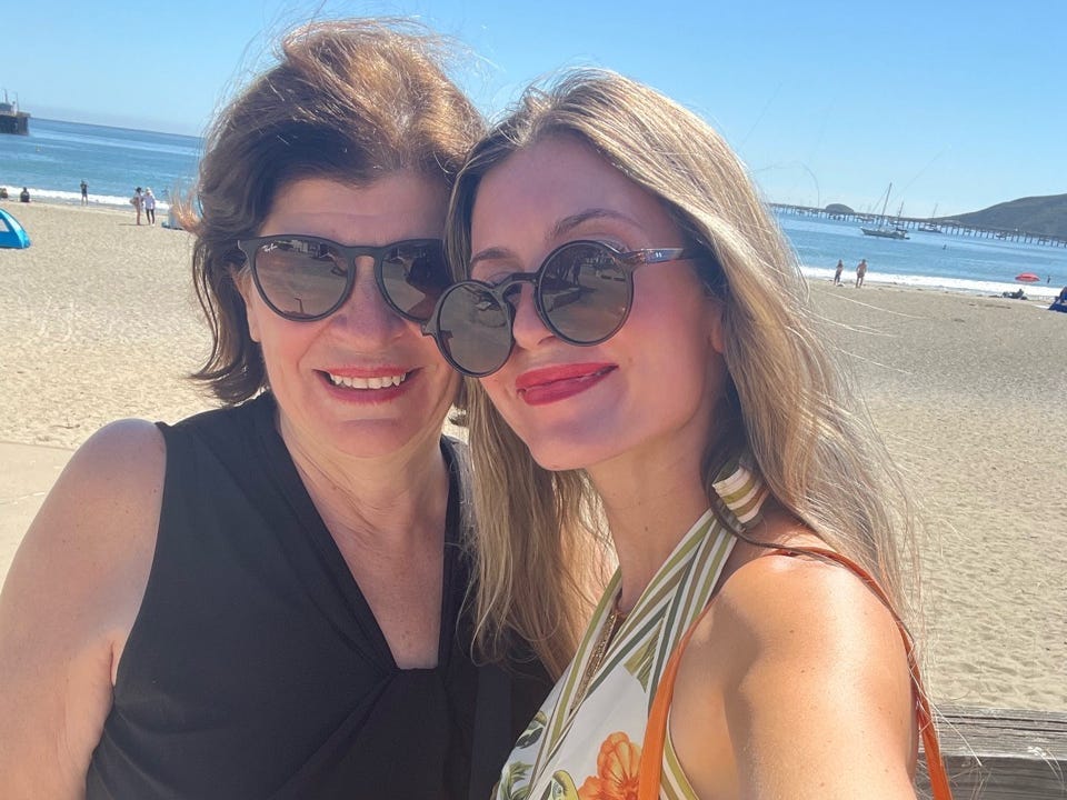 Author Alexa Mellardo and her mom smiling on a beach