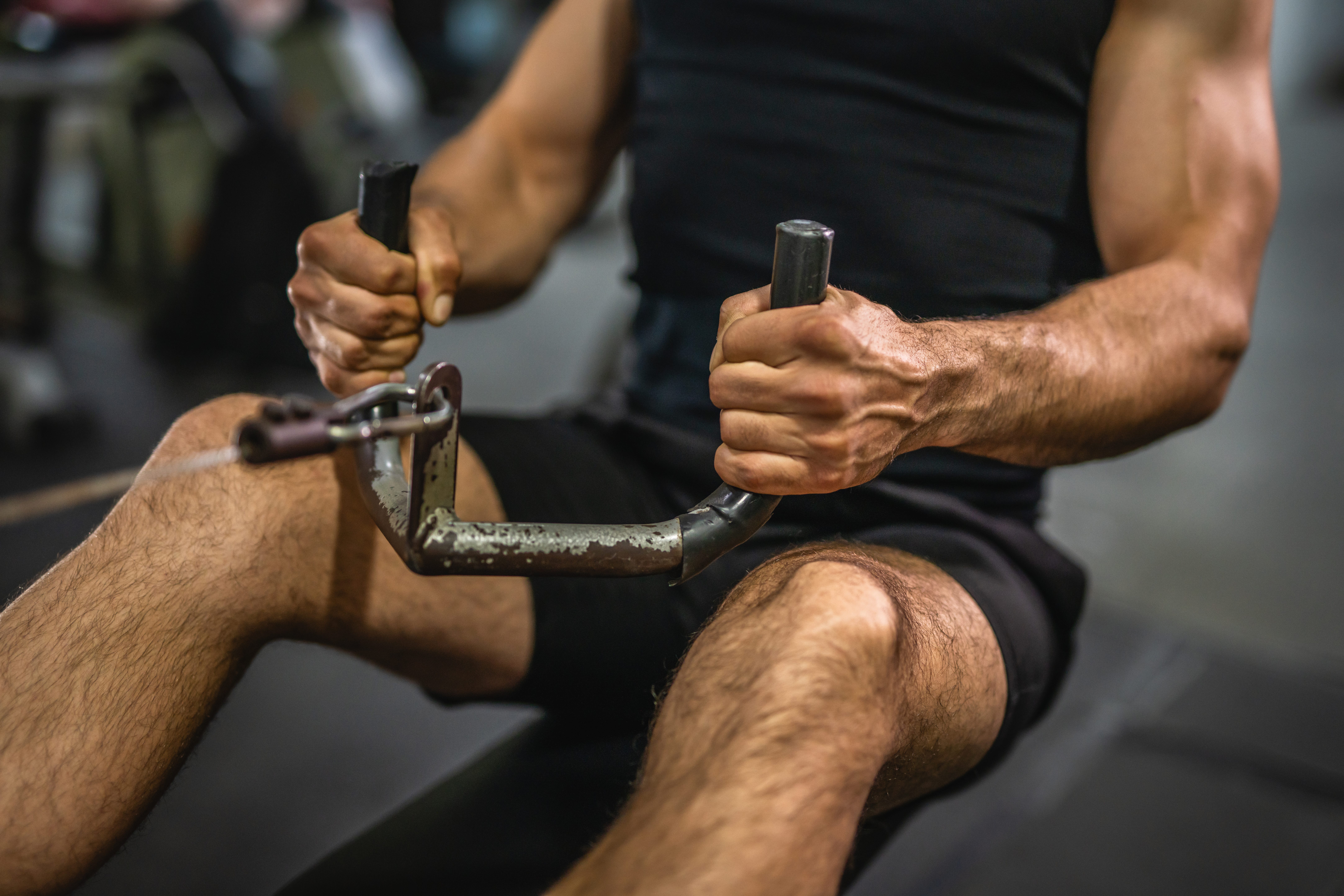Man on a pull machine at the gym.