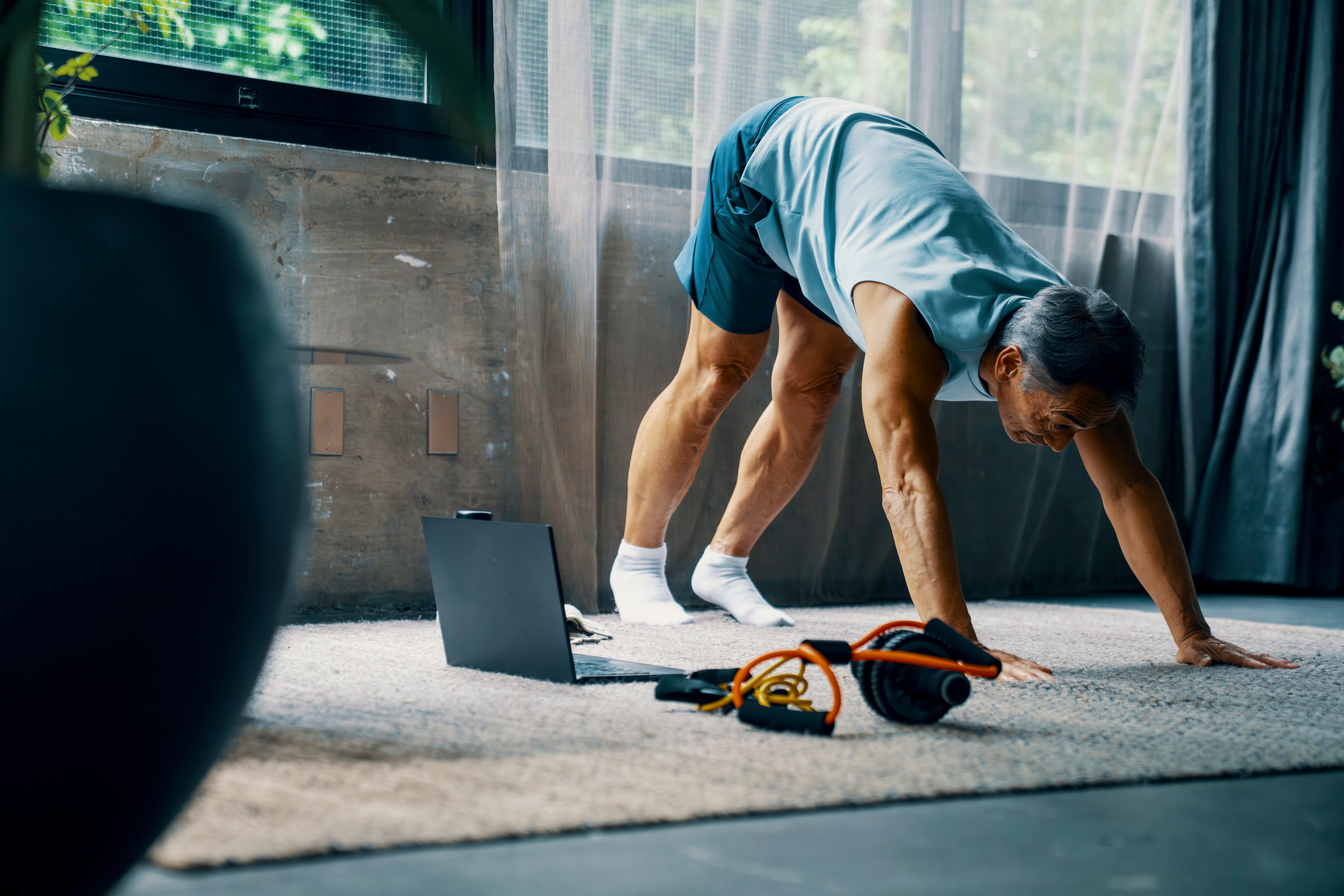 A man stretching at home.