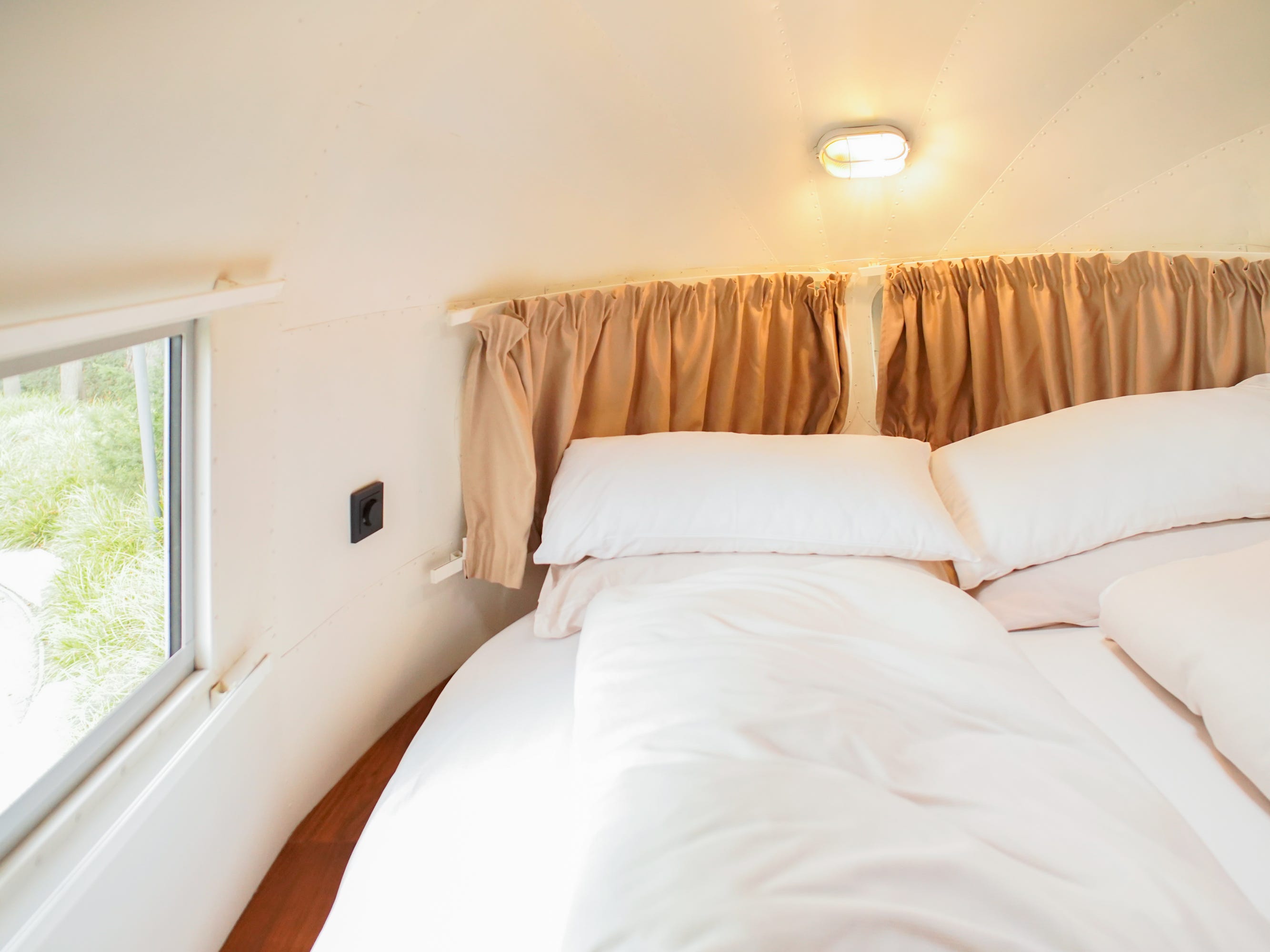 The bed inside the airstream trailer.
