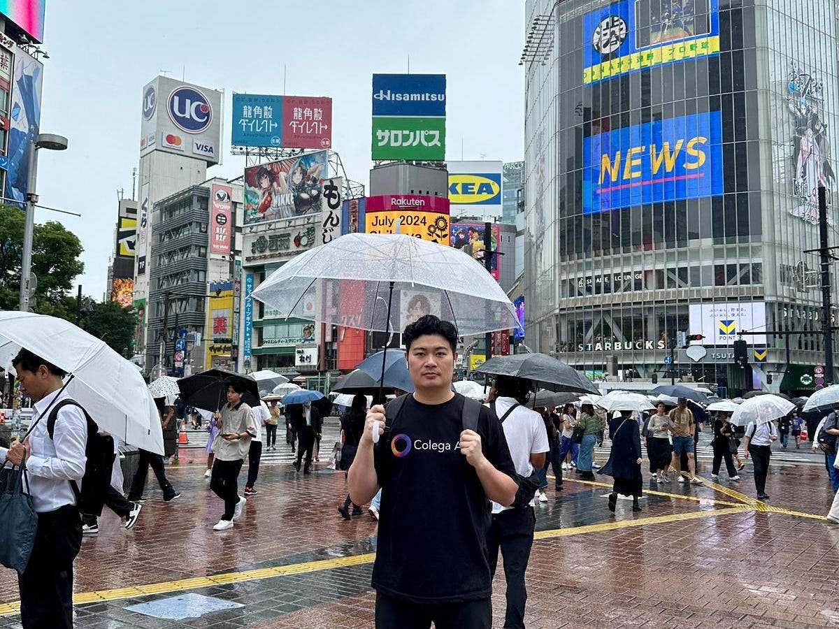 Eric Fung is standing under an umbrella in Tokyo.