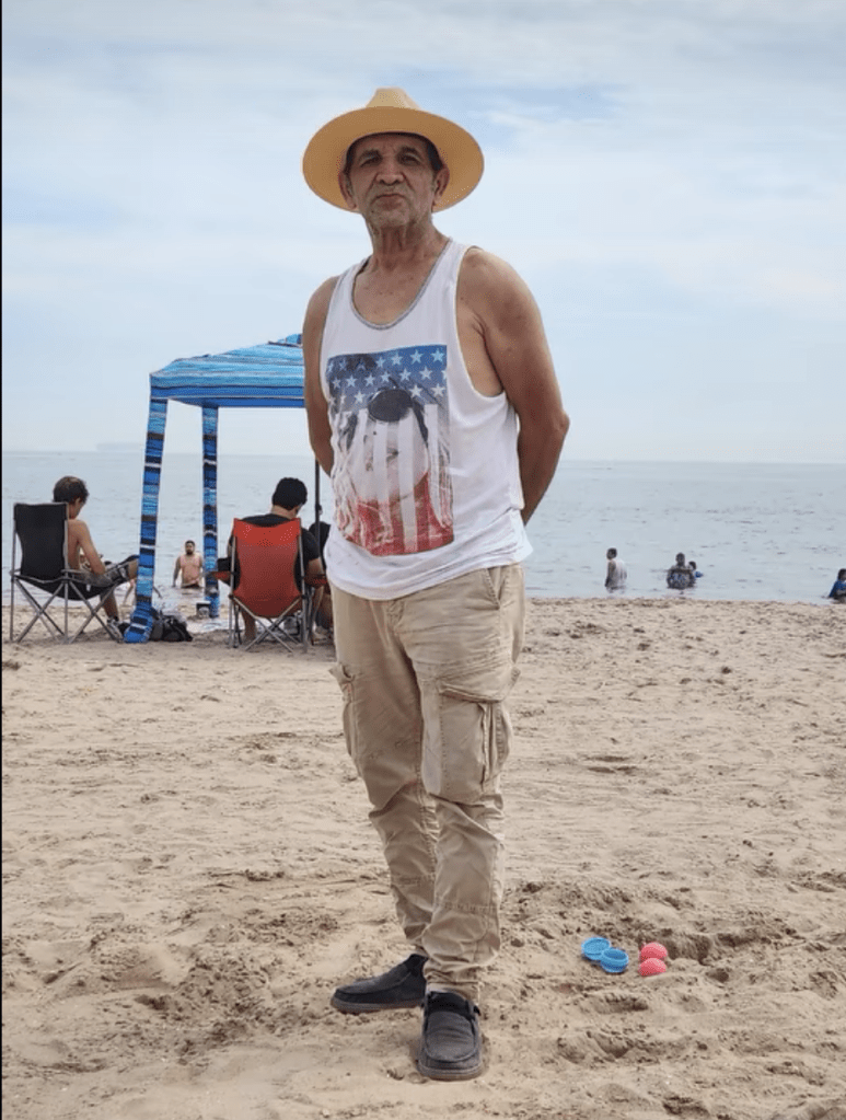 Leobardo Hernandez, 64, standing on a beach.