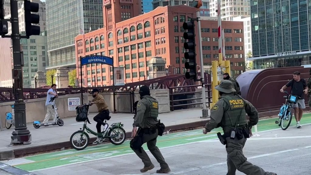 Video of the encounter shows the unidentified cyclist riding up to a cluster of agents on Sunday during federal immigration patrols in Chicago.