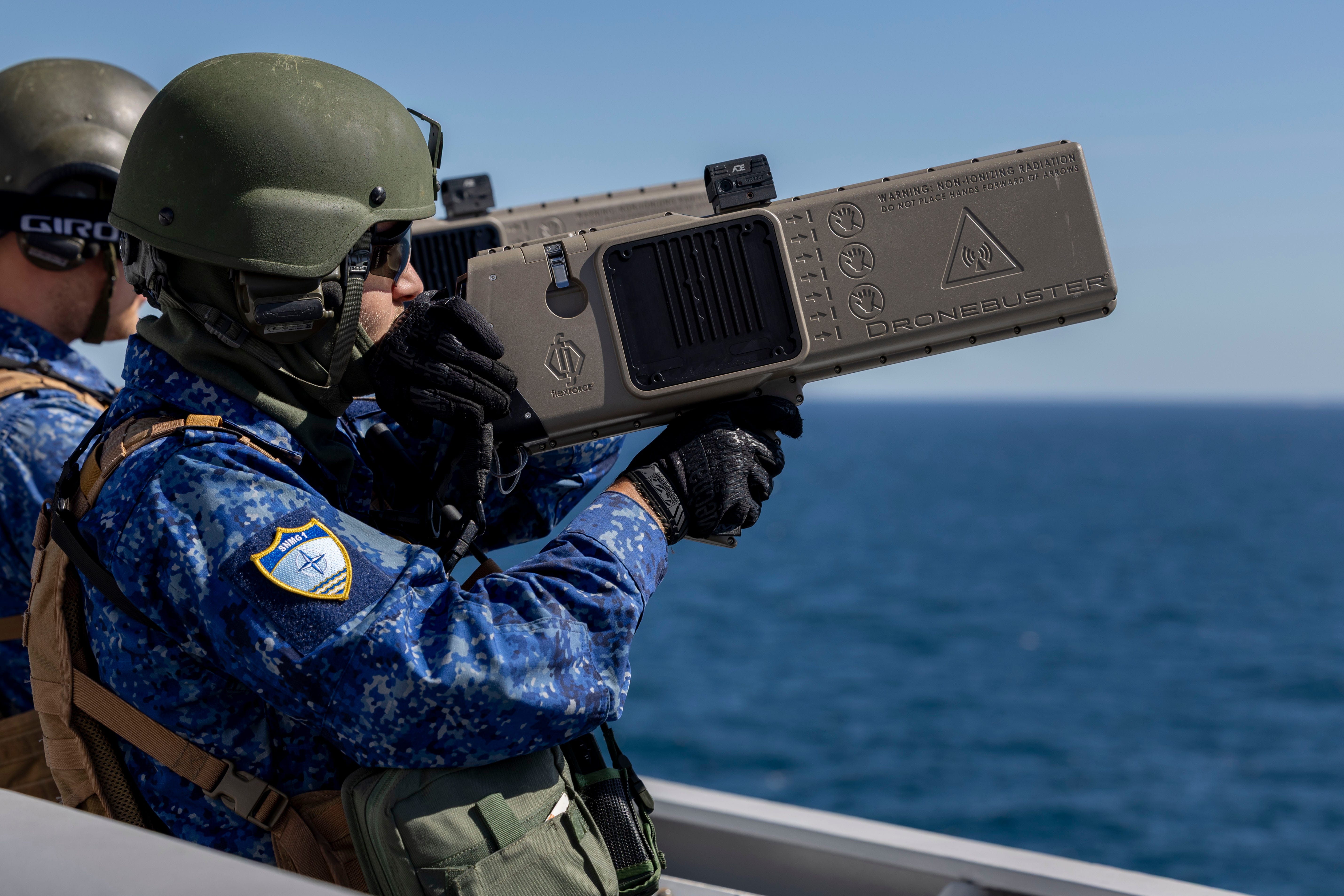 A NATO soldier holds a counter-drone device.