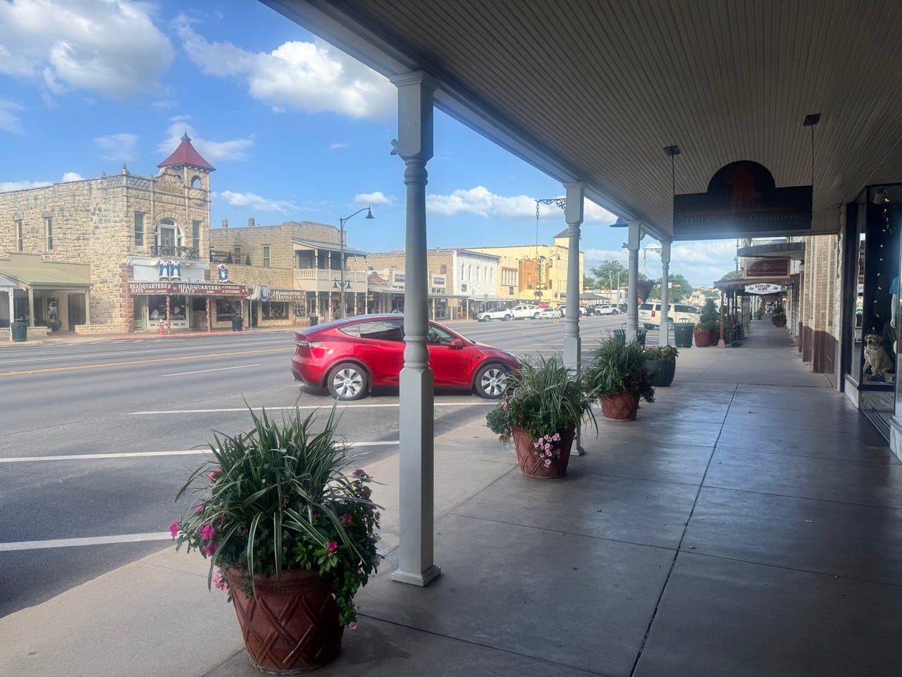 Main street area with empty parking spots, plants
