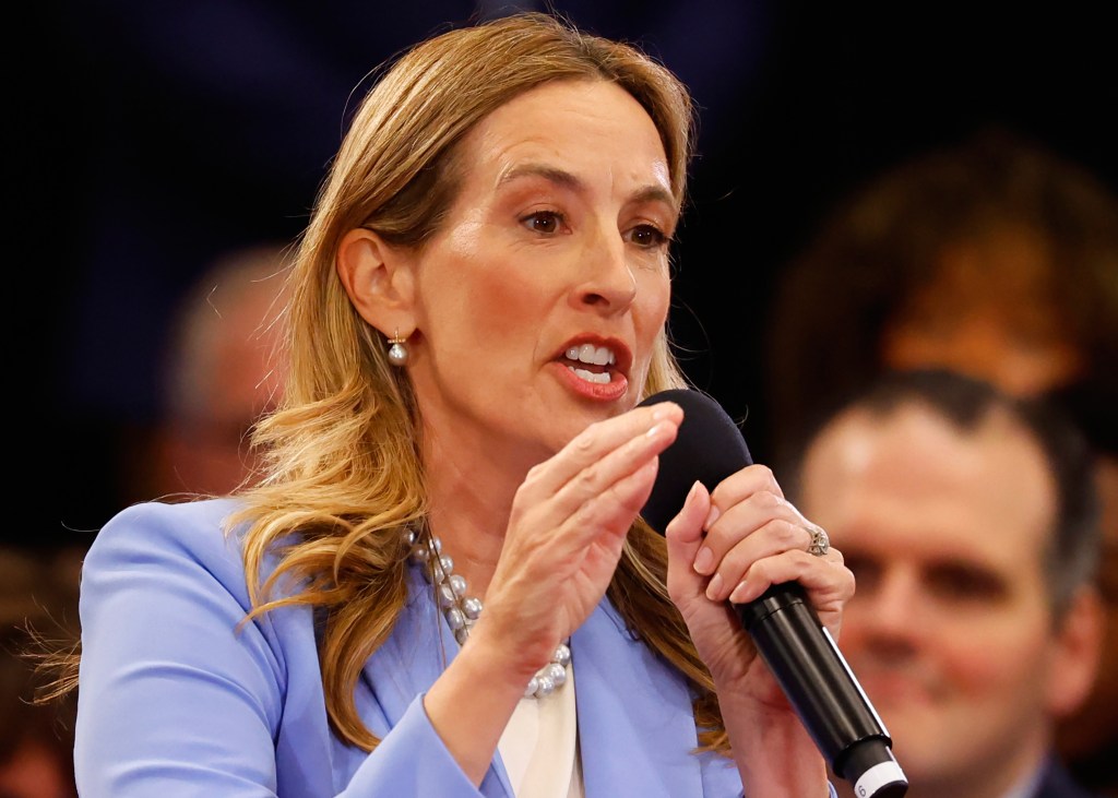 Democrat Mikie Sherrill speaks into a microphone at a debate.