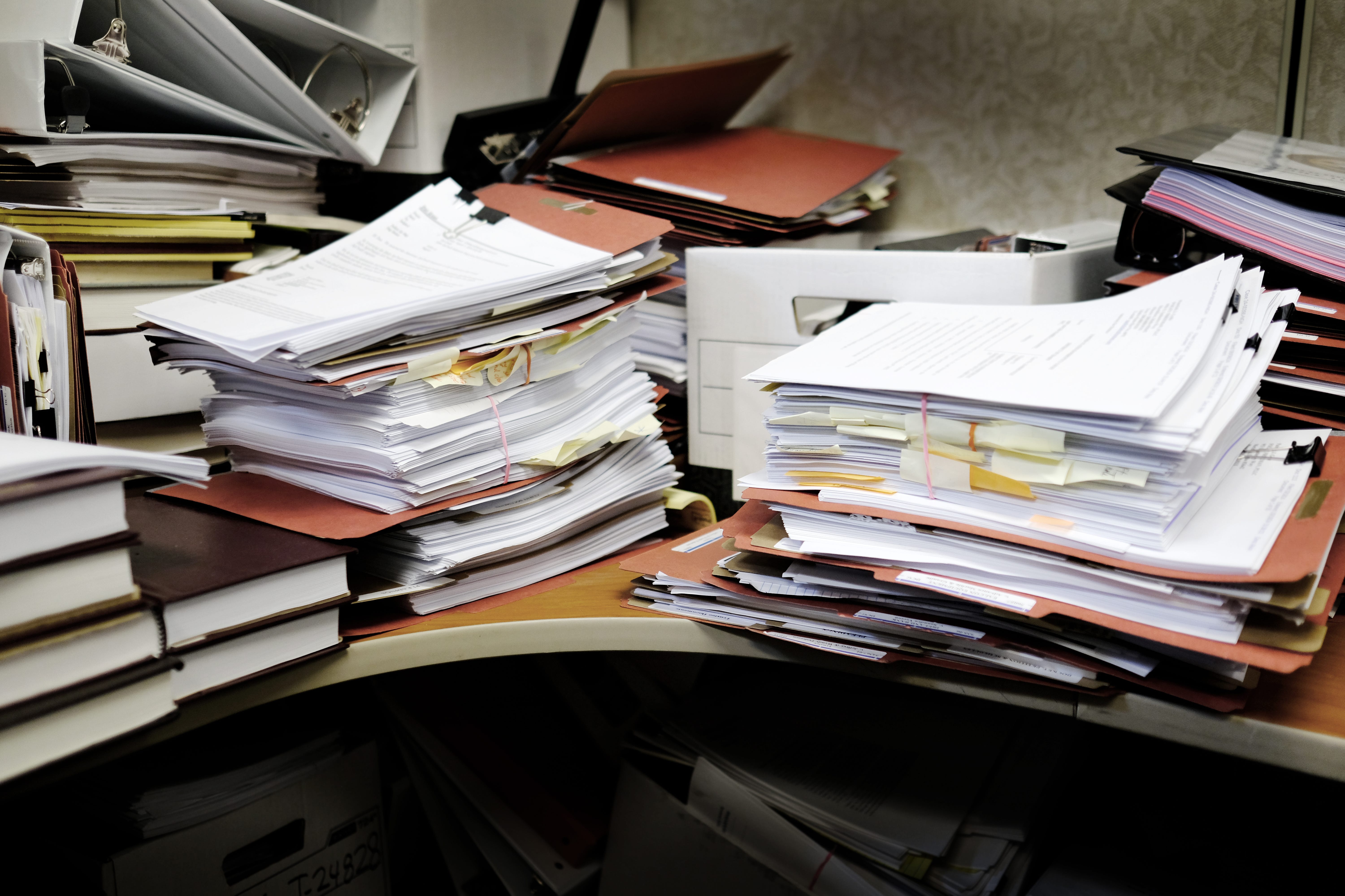 Table piled with paperwork, binders