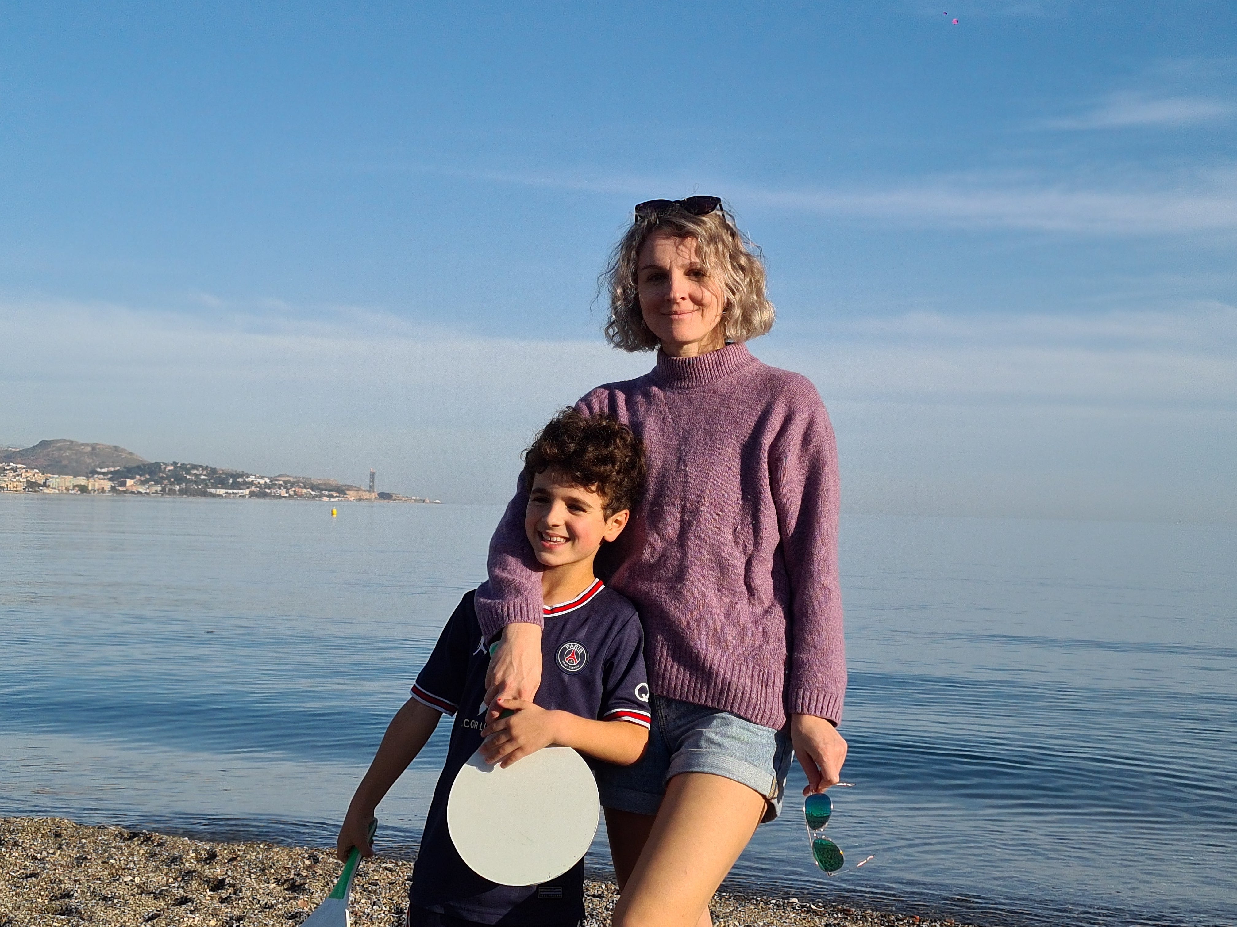The author and her son stand on the beach in Malaga.