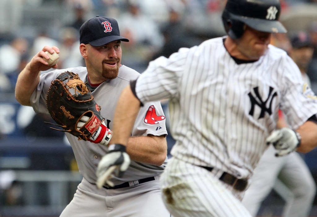 Kevin Youkilis #20 of the Boston Red Sox throws out Brett Gardner #11 of the New York Yankees on September 27, 2009.
