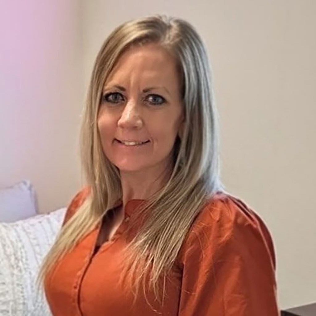 Hiker Heather Wayment in an orange shirt.