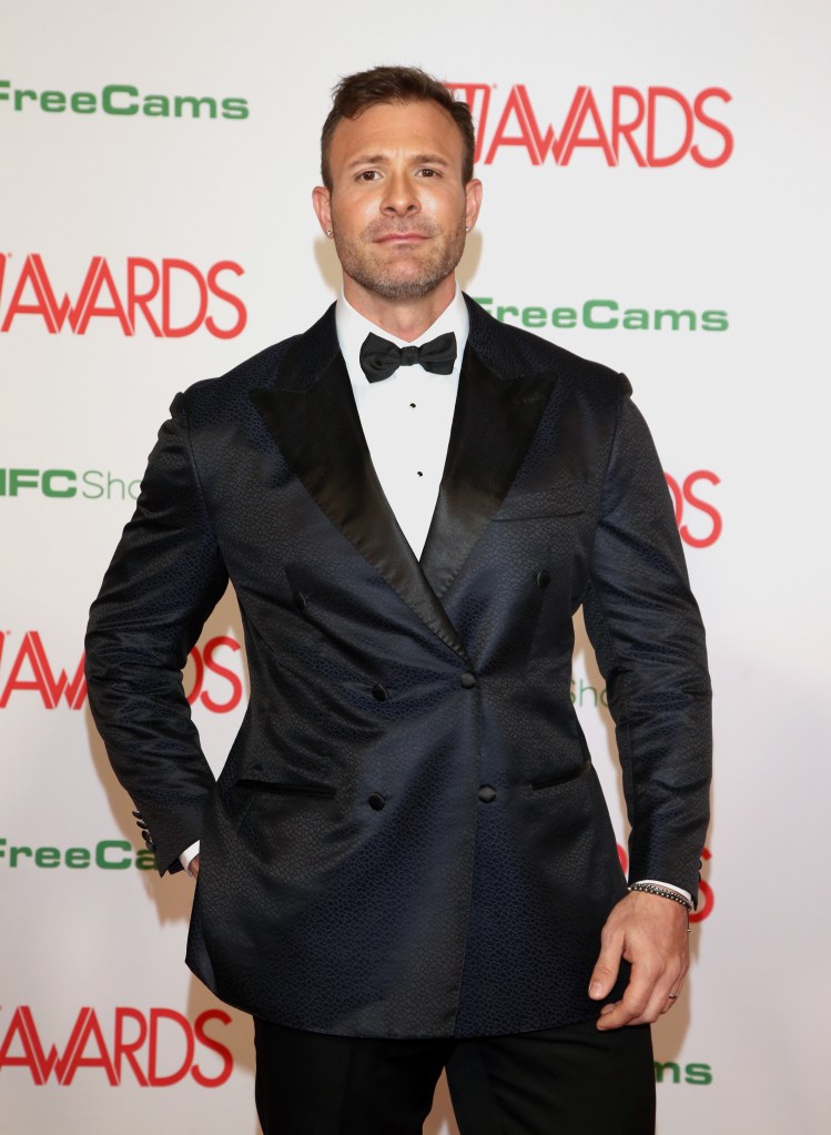 Austin Wolf in a black double-breasted tuxedo jacket with patterned fabric and a black bow tie.