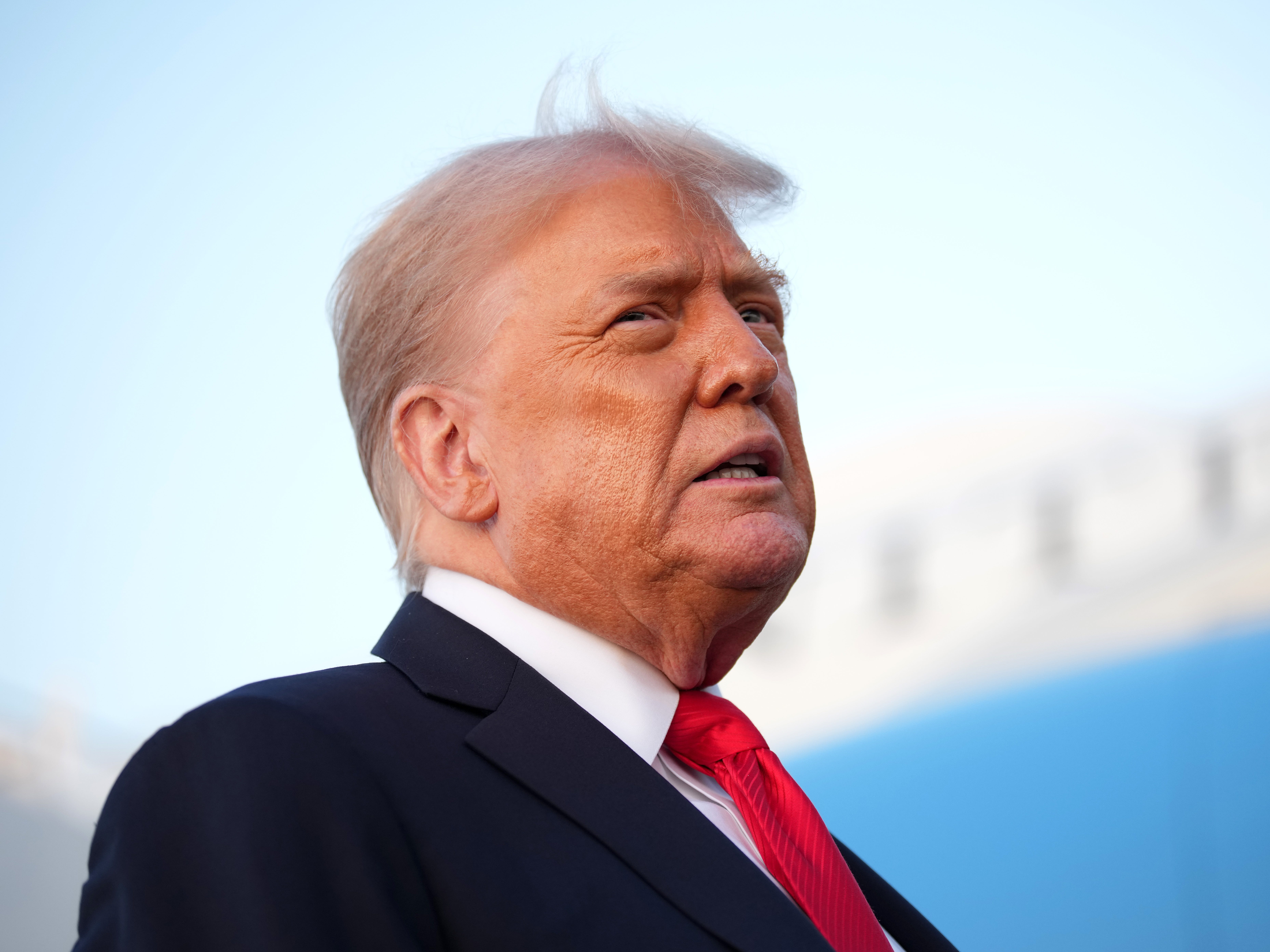 President Donald Trump speaking to reporters beside Air Force One.